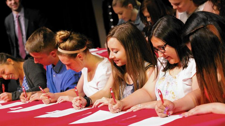 Determined to recruit and support the next generation of teachers for local schools, officials at Township High School District 214 recently launched an Educator Prep initiative. Pictured here are students signing up for the program at its May 26 launch. Karen Ann Cullotta / Pioneer Press. May 31, 2016. (Township High School District 214 / Handout)