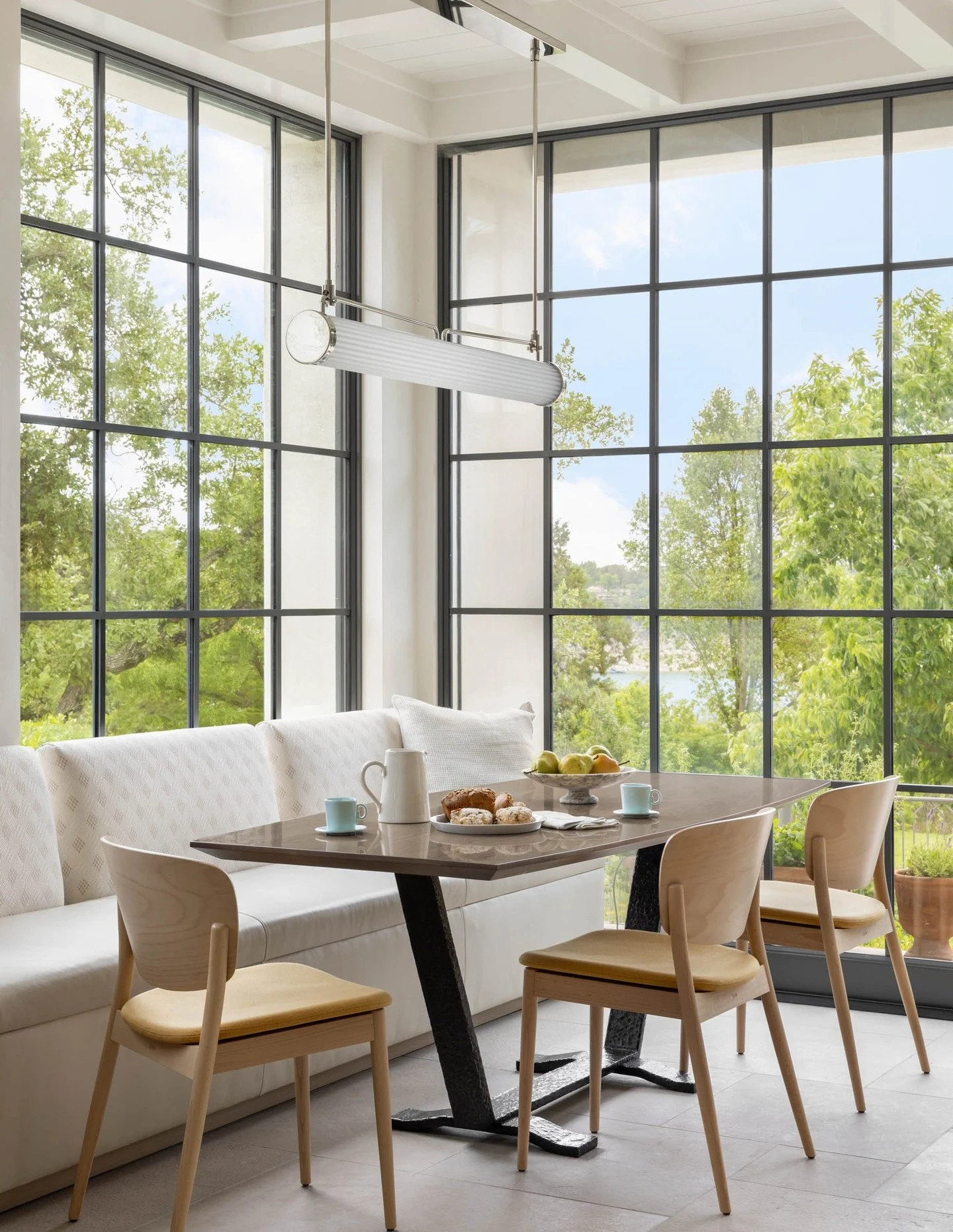 At our Lakeside Retreat, the kitchen frames a stunning view of Lake Travis. From the start, we aimed to make the most social room of the house the one with the best sightlines.

A grid of steel windows and doors opens up to a view of the lake toward 