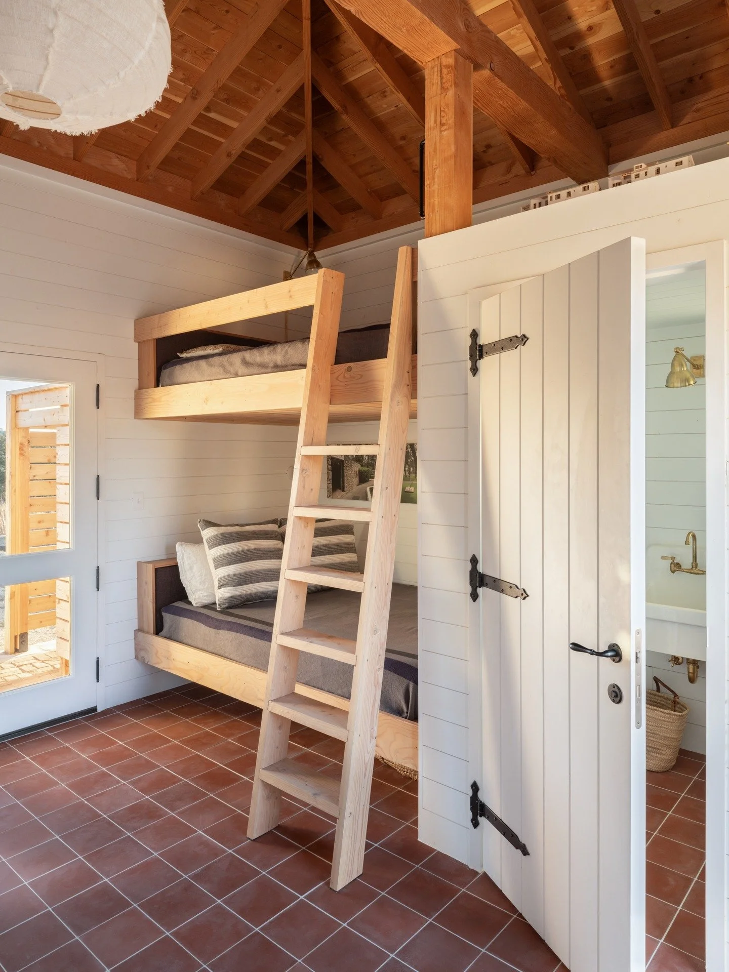 The Pump House at our Walnut Springs project has built-in queen bunks, work space, and walls lined with pine boards. We were thrilled to come upon some beautiful long leaf pine countertops, sourced from our friends at Save the Good Stuff in Hyde Park