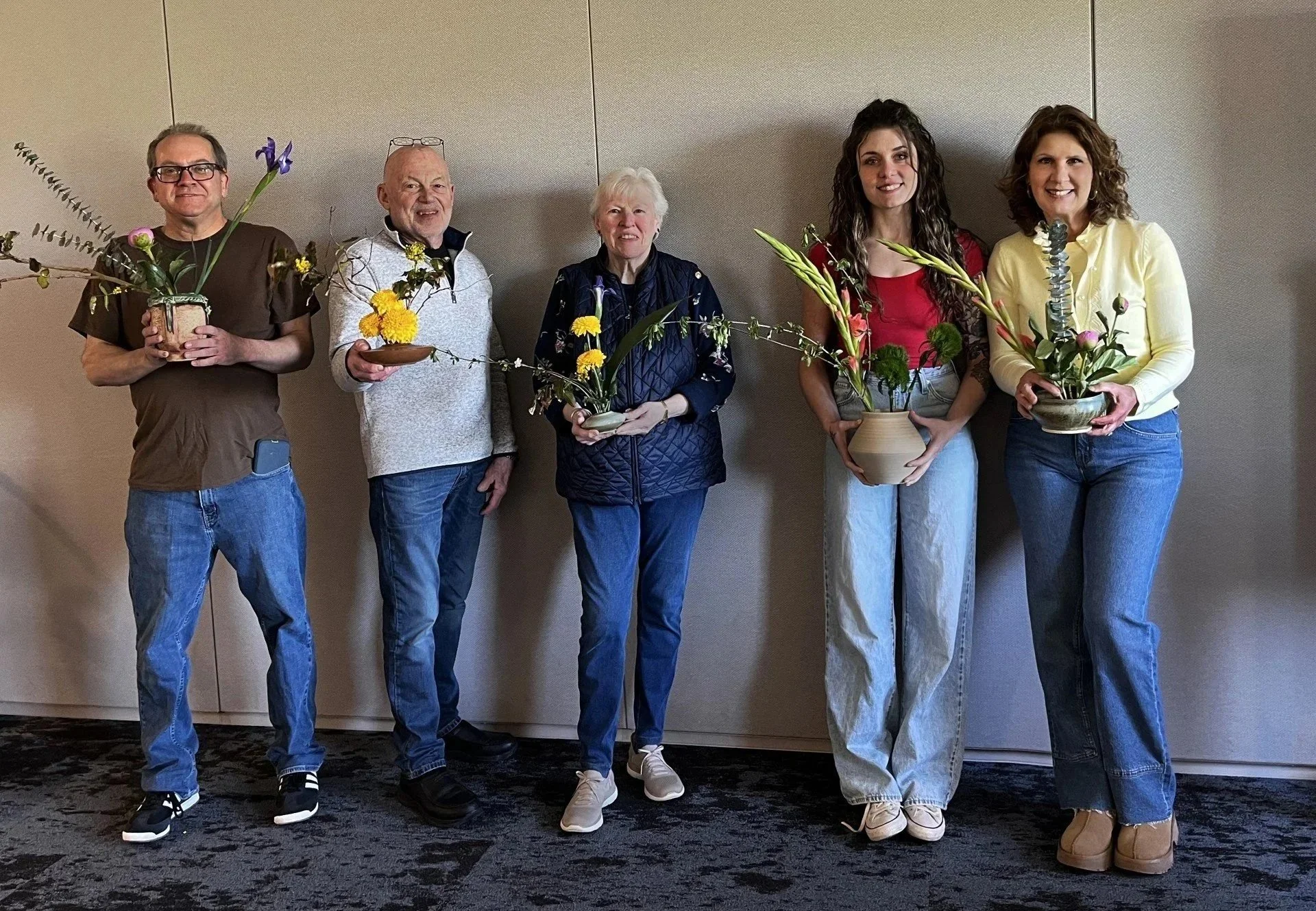 The participants show their Ikebana creations.