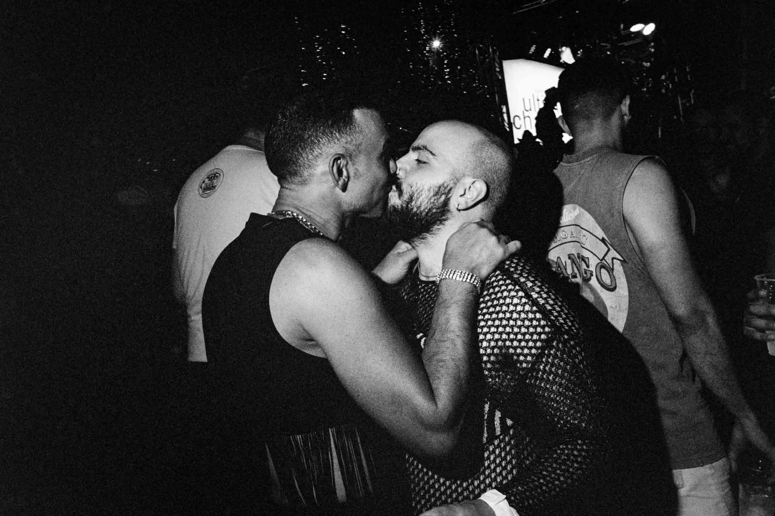 Two men are kissing at Manchester Pride.