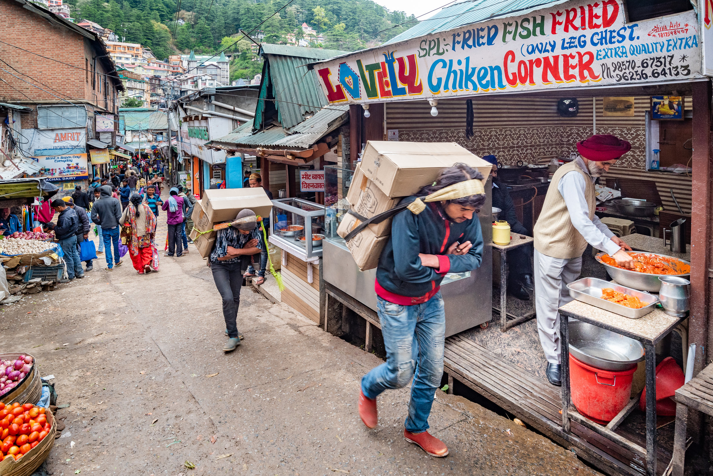 The Khans carrying supplies up the hill slopes to the shops