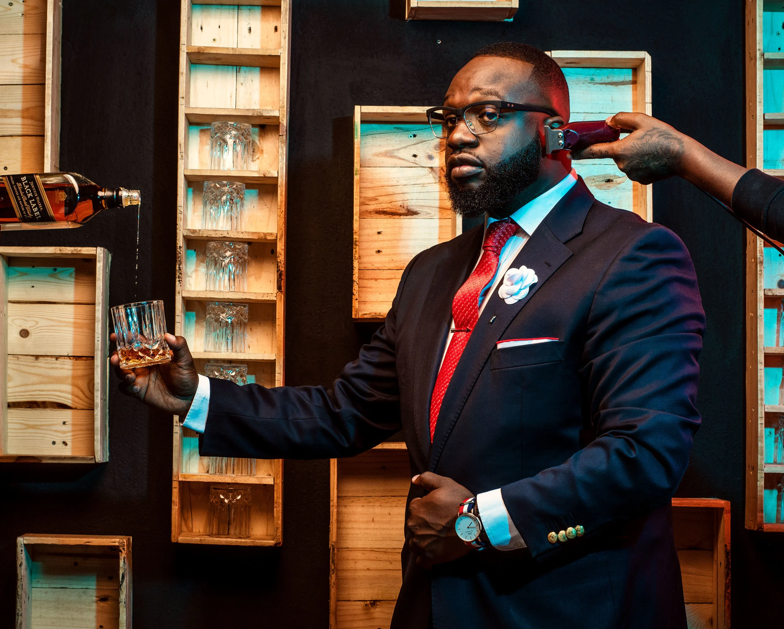 Man in a suit with drink and haircut