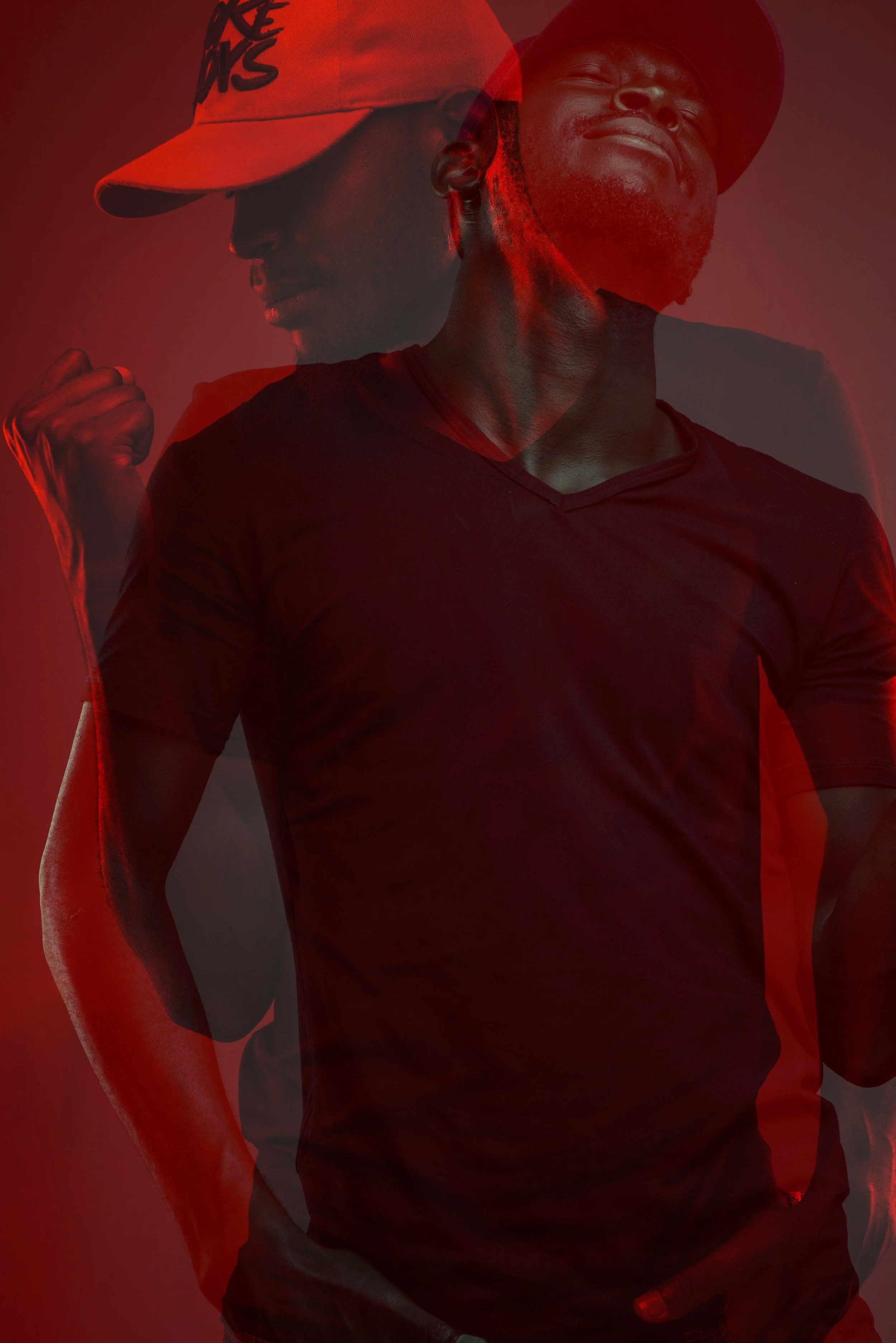 Double exposure photo of a man in a cap and black shirt against a red background, showing two different poses with one arm raised and the other relaxed.