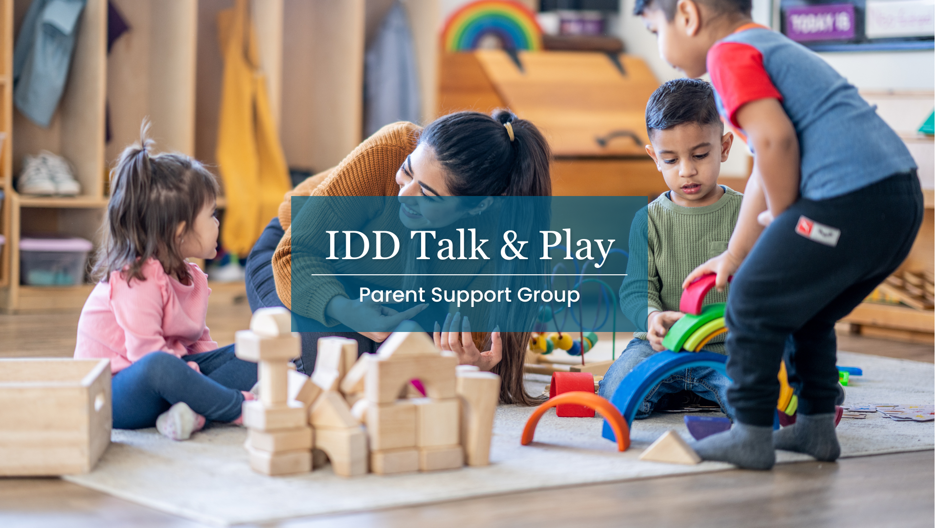 IDD Talk & Play Parent Support Group. Image Description: Children engage in free play with blocks and toys