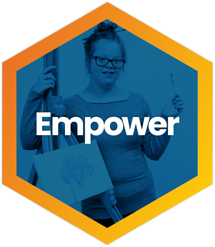 A young woman with glasses and her hair in a bun smiles while holding a paintbrush and standing next to an art easel. The image is set within an orange hexagonal frame with a blue color filter. Large white text in the center reads "Empower."