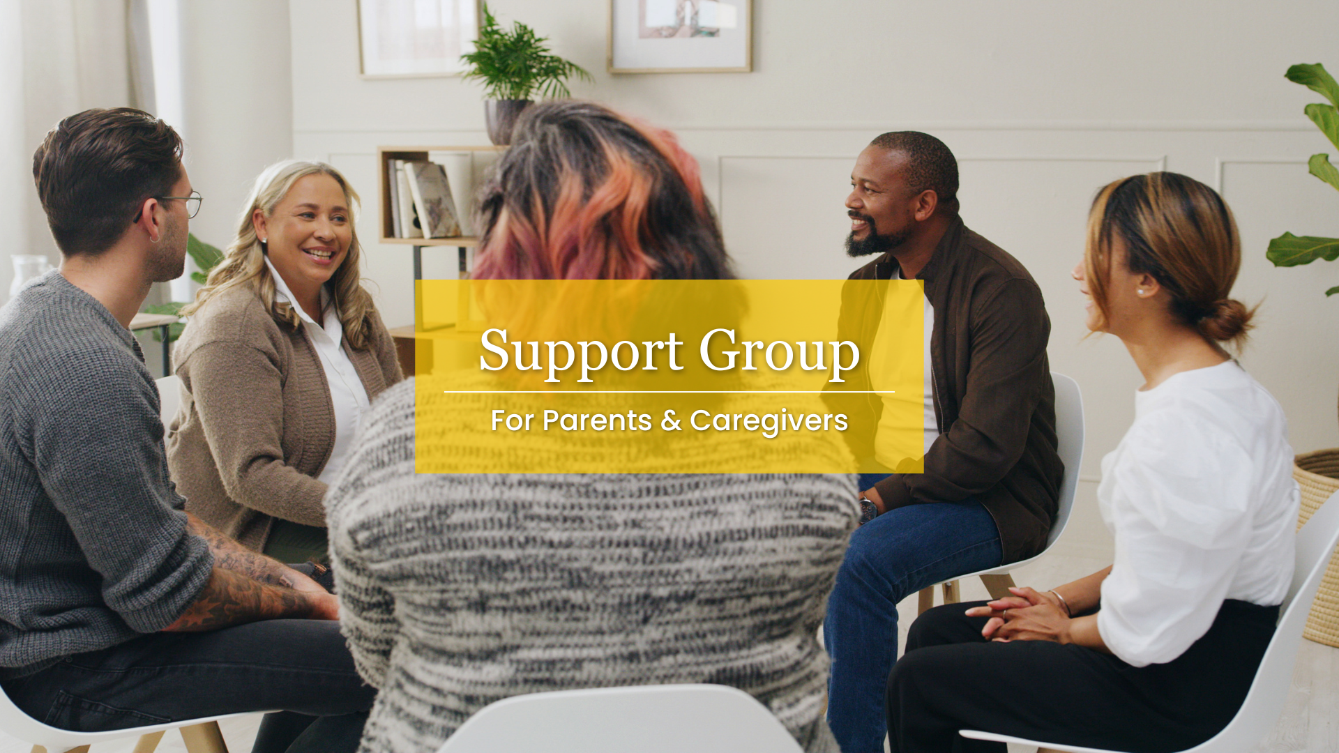 Support Group For Parents & Caregivers. Image description: A group of men and women sit together in discussion