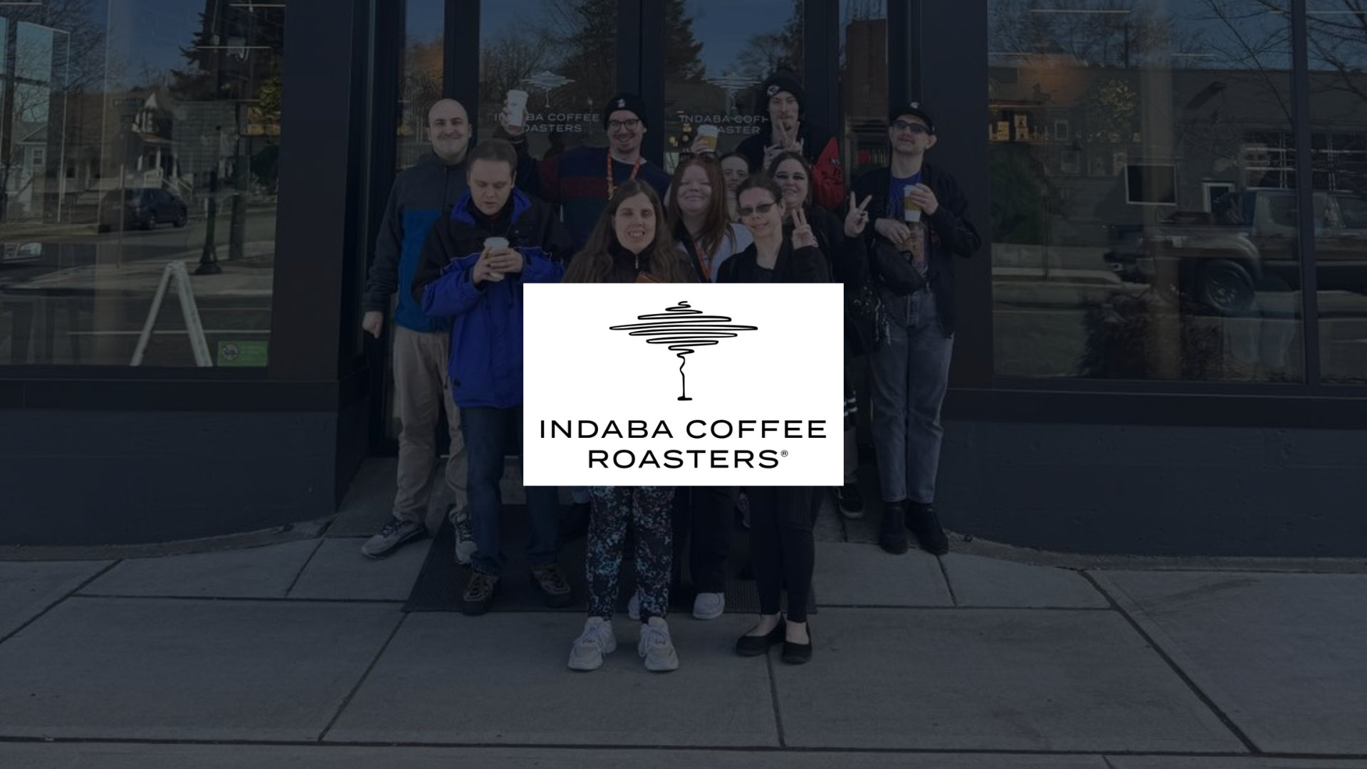 Members of The Arc's community center stand in front of Indaba coffee