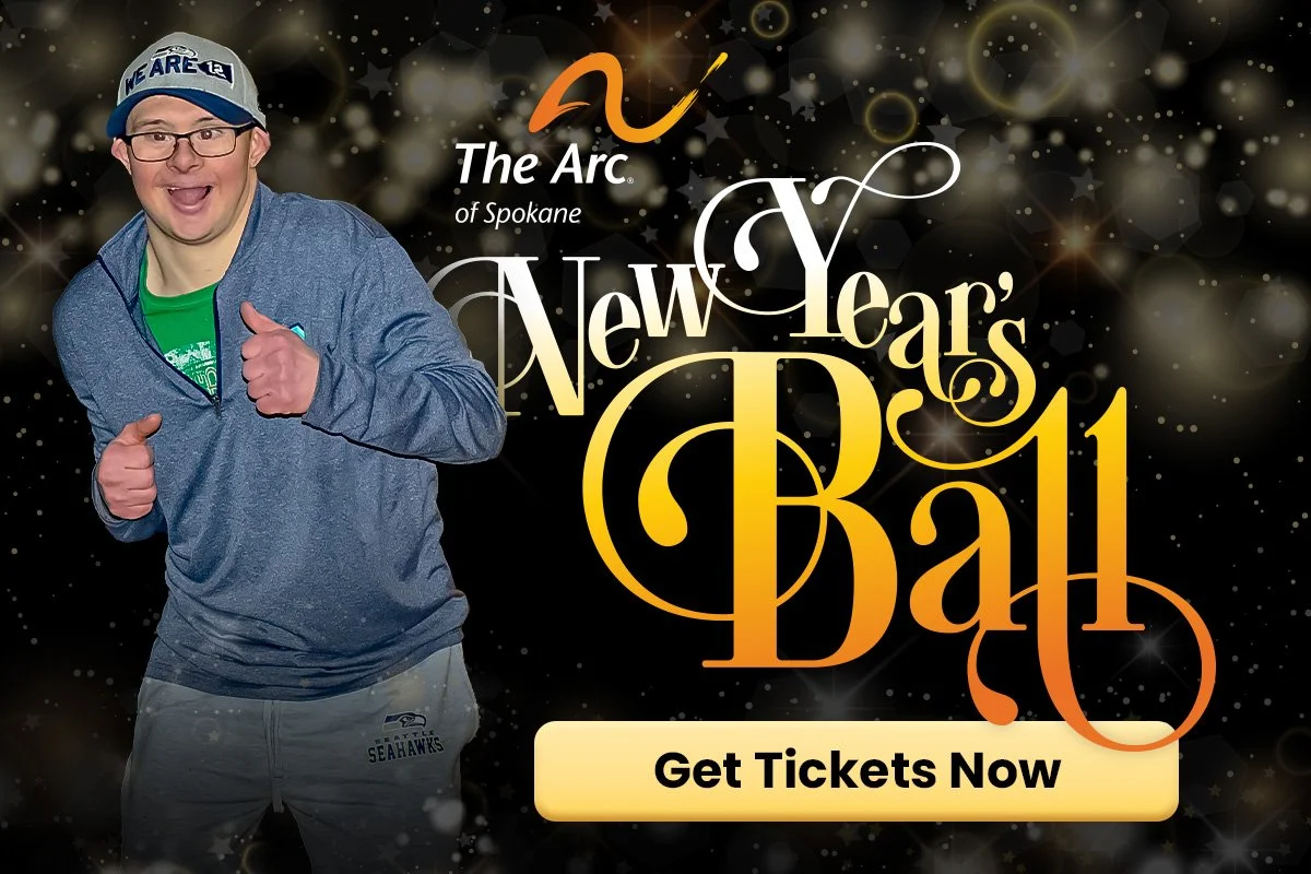A person smiling and giving a thumbs up in front of a New Year's Ball graphic.