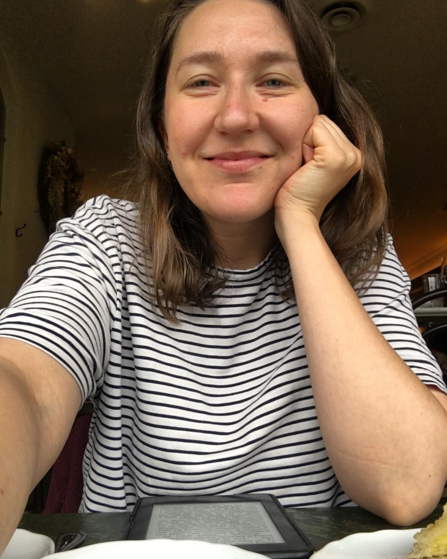 This is 35!⁣
⁣
Image description: A selfie of Leanna smiling while sitting, wearing a striped white and navy blue slouchy t-shirt.