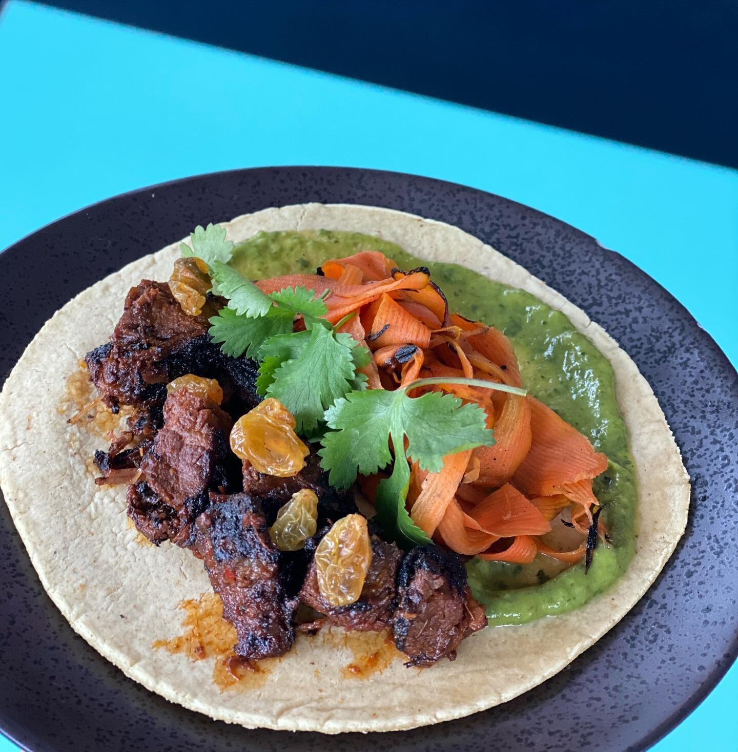 Steak Guisado Taco Special! Enough heat to warm you up on this rainy SD day. Not to worry the golden raisins are there to counter the heat with a touch of sweetness! #tacotuesday 

Steak Guisado
+ Avocado mousse
+ Mesquite shaved carrot
+ Golden rais