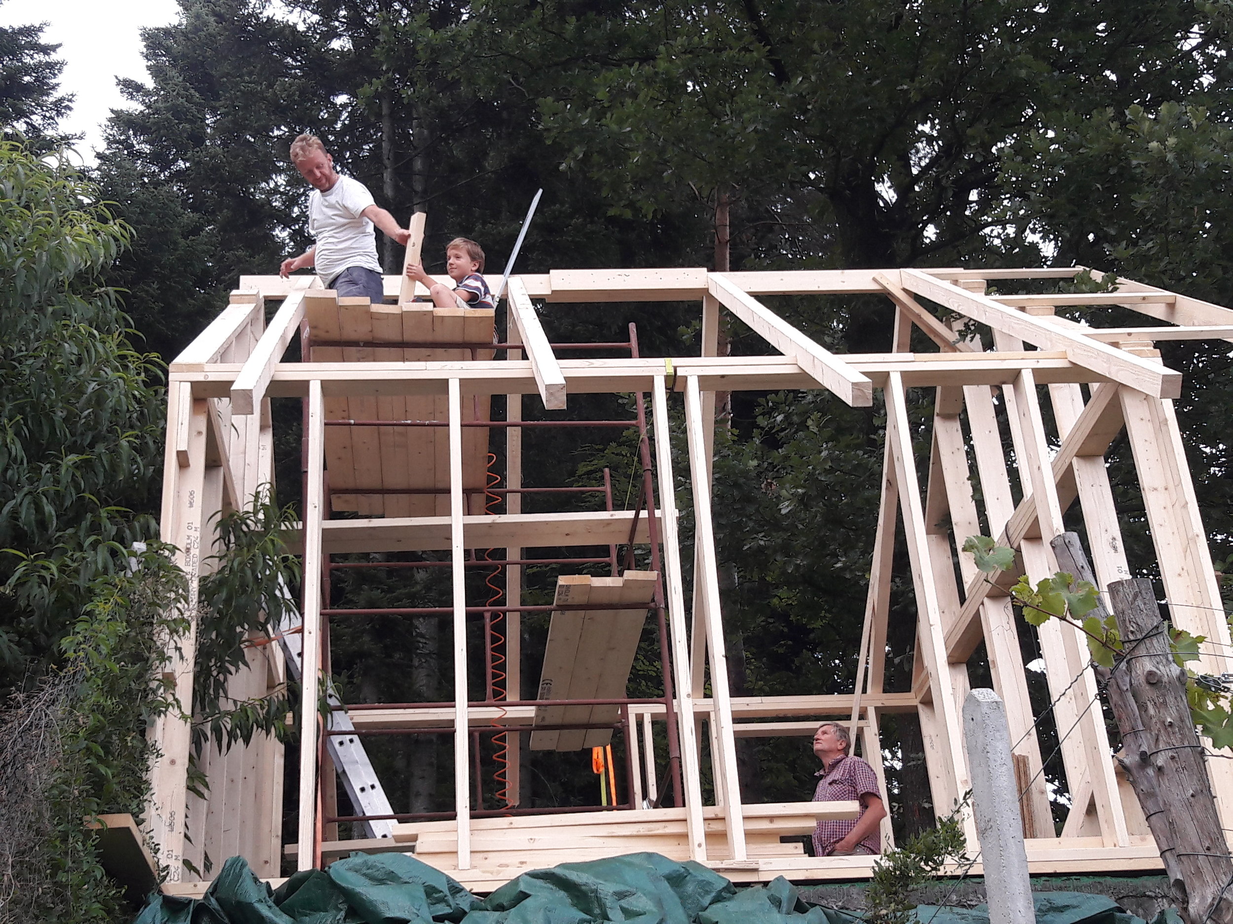 Michal building an apiary workshop with his father and son