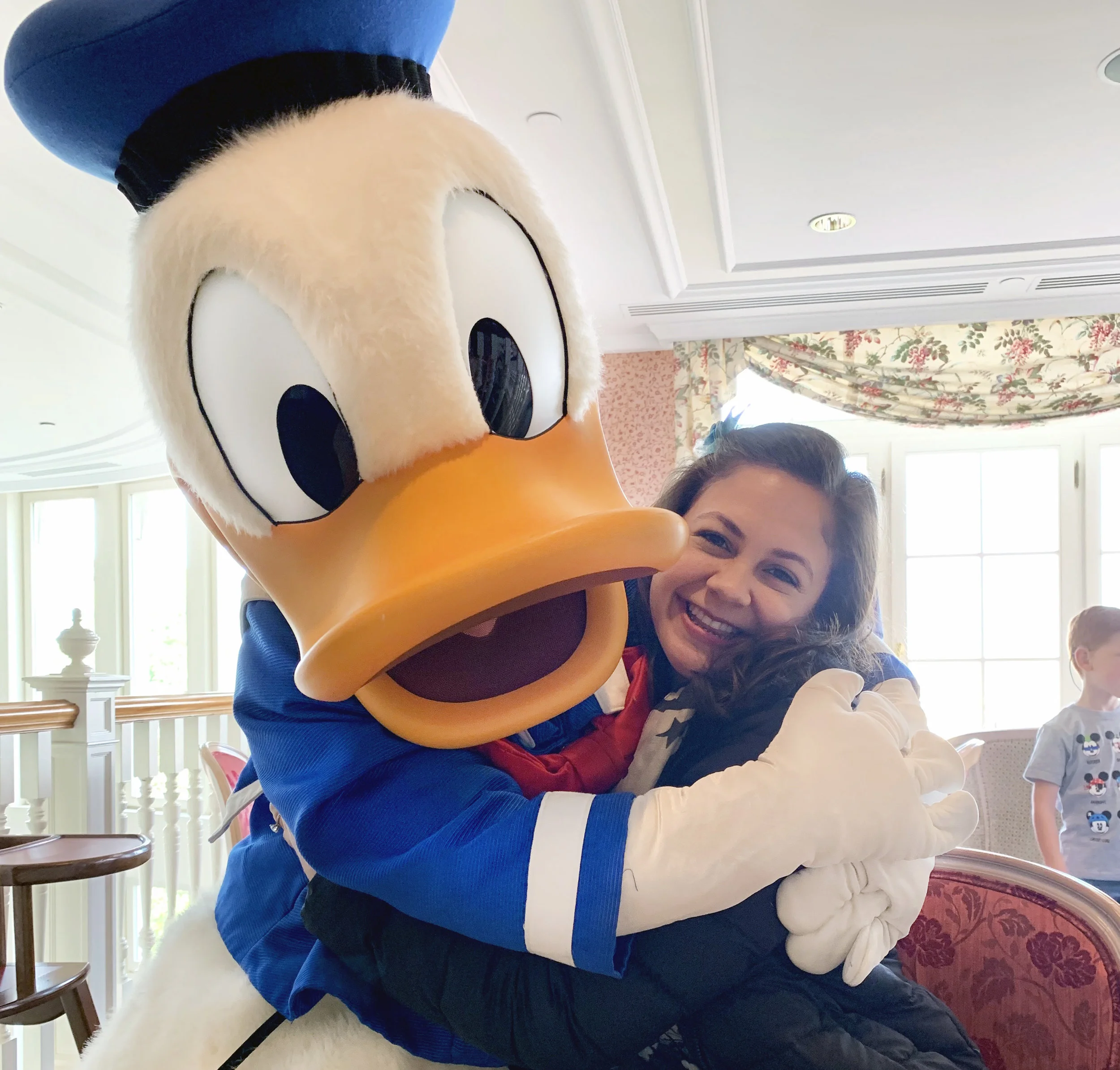 Andrea posing with Donald Duck in Disneyland Paris.