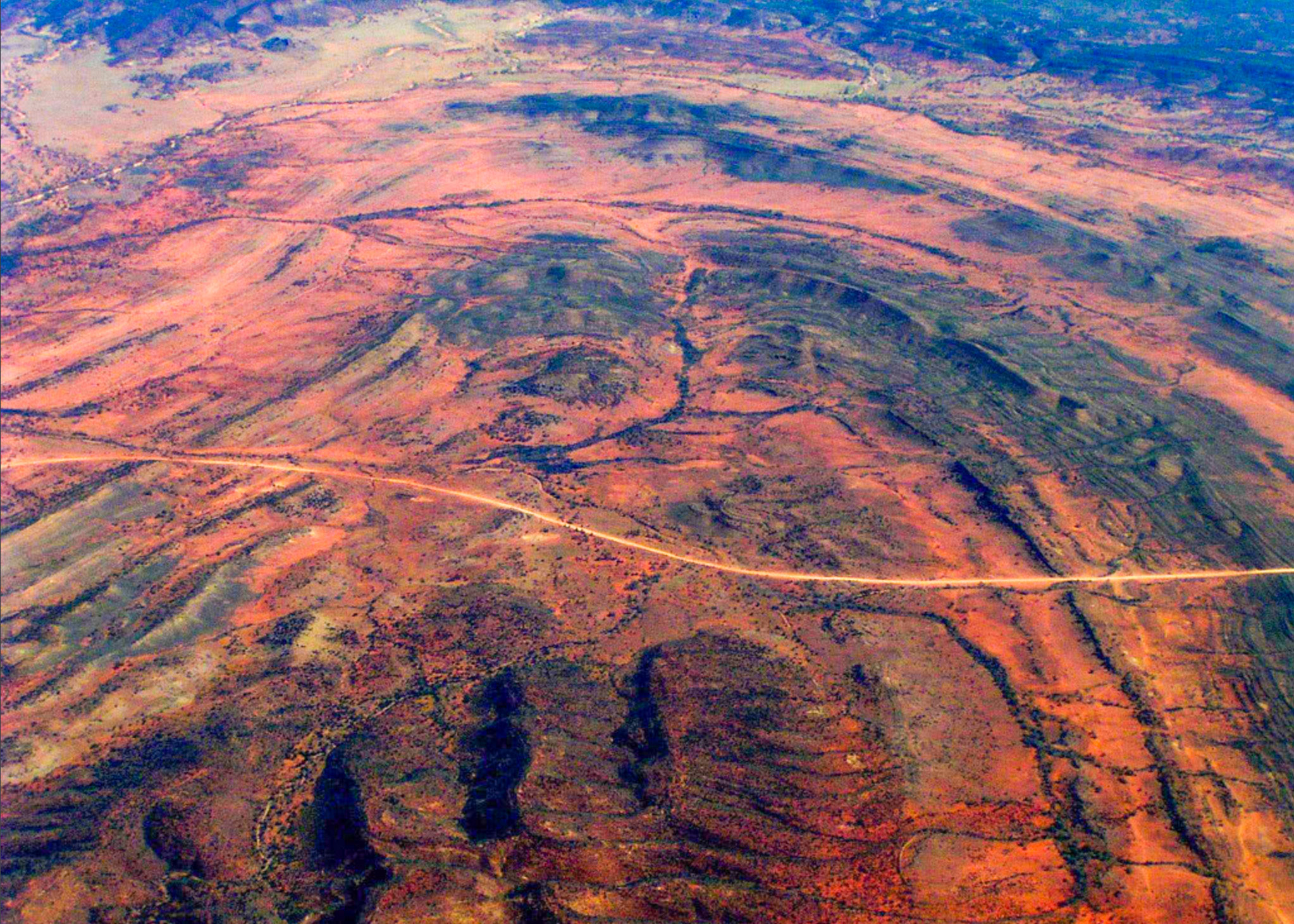 Mesmerising curved patterns of the Simpson Desert in Queensland, as seen from above. They are visual expression of folded planar surfaces of rock layers intersecting the Earth’s surface. Image: Dietmar Müller via Flickr .