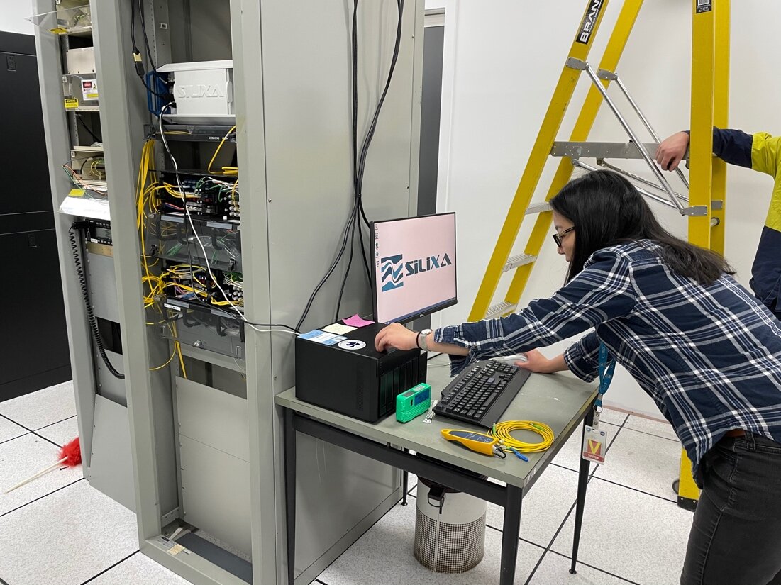 Voon Hui Lai sets up the DAS interrogator for the first time in the DSN server room. Image: Meghan Miller