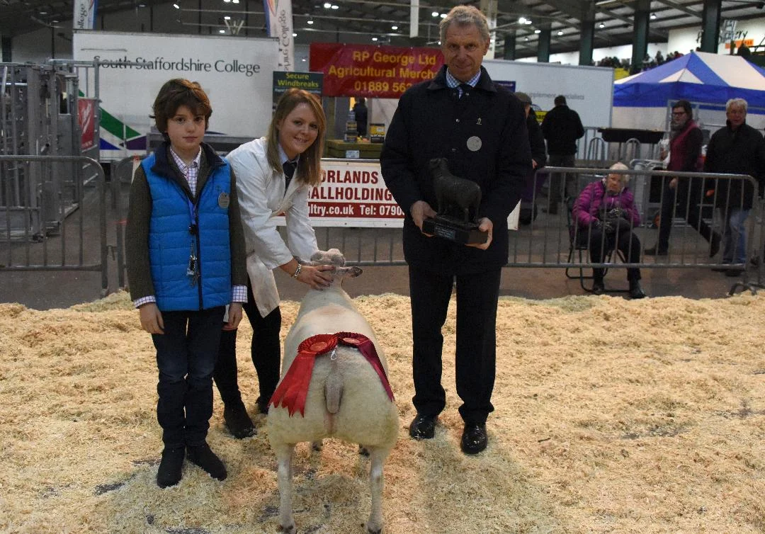 RABI Single Butchers Lamb winner Sarah Priestley pictured with Royal Smithfield Club Chairman, William Bedell, and son Freddie