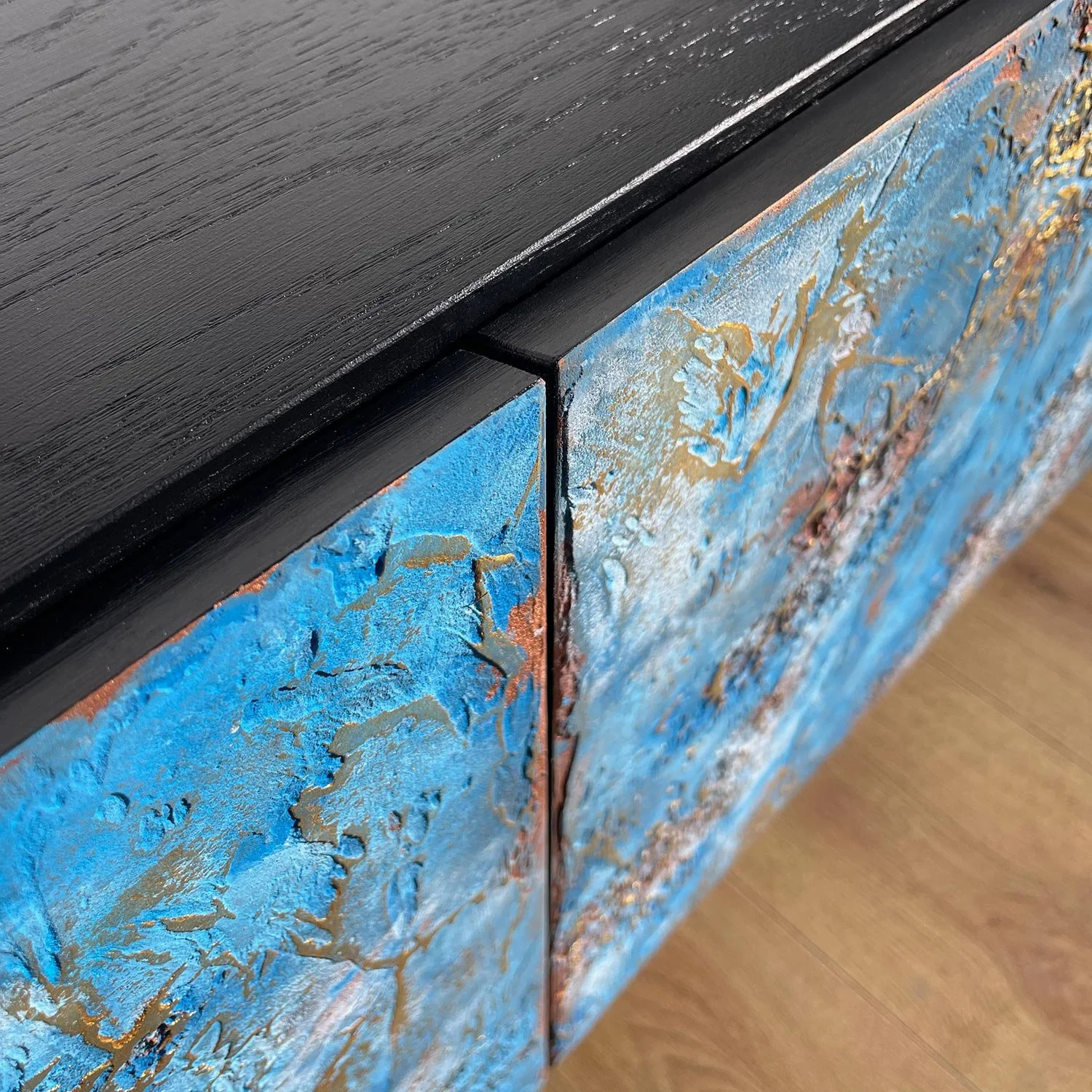 Close view of textured door panels and minimalist mitred handle on custom textured sideboard.