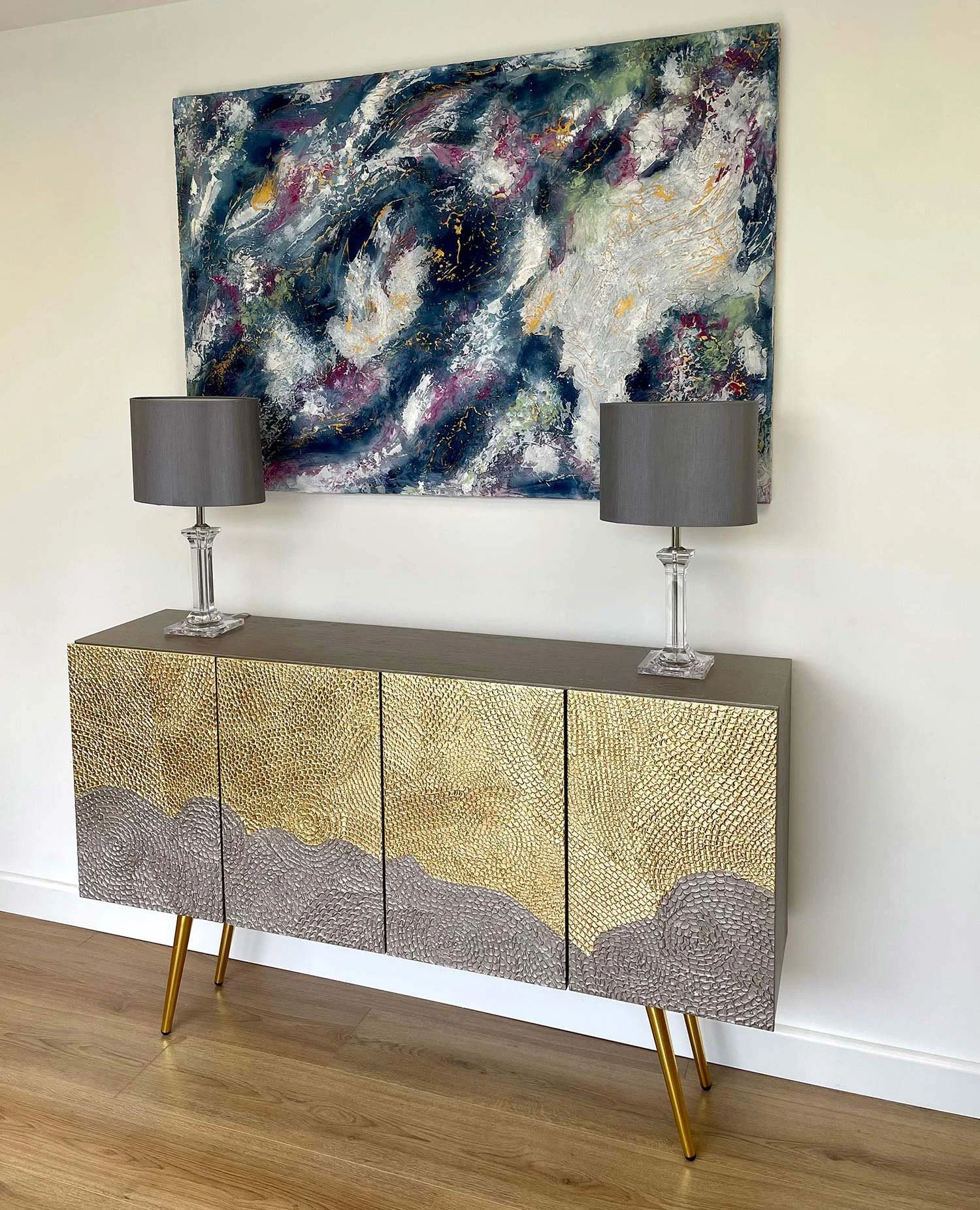 Side view of the Gilded Horizon luxury credenza showcasing the seamless 3D organic texture wrap and elegant gold tapered legs.