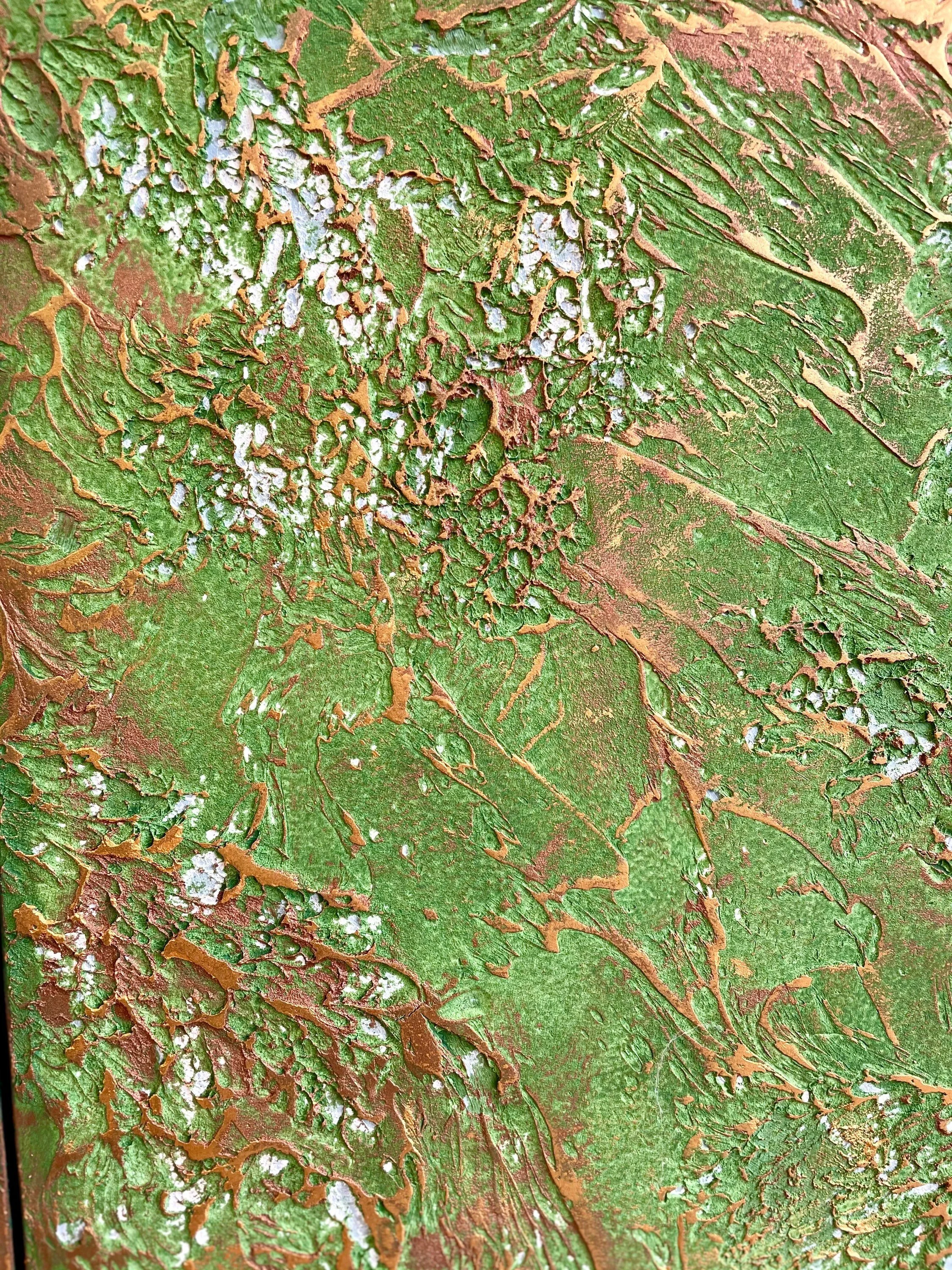 Close-up of a textured surface with green and brown colors, featuring intricate patterns resembling leaves or organic matter.