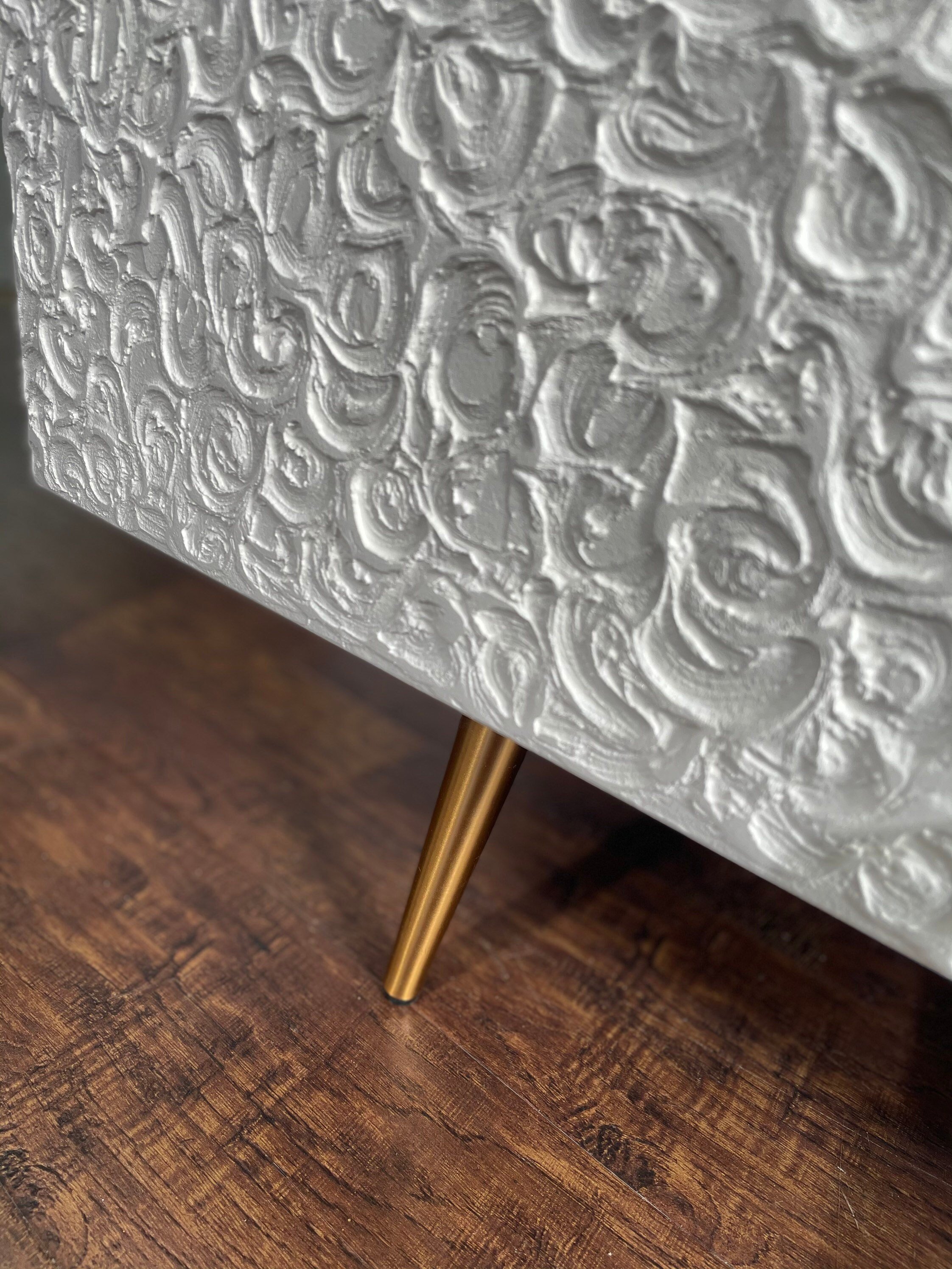 Close up of beautifully textured doors and 20cm gold feet.