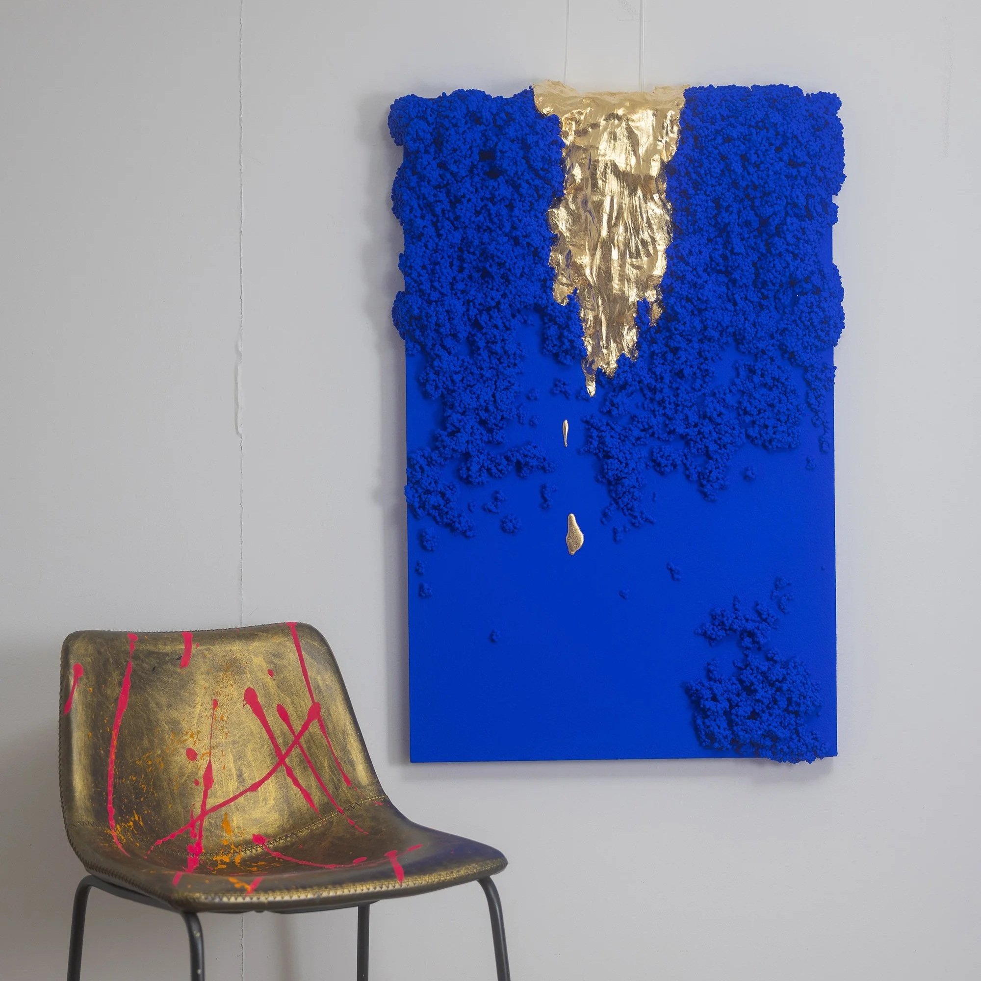 Original blue sculptural wall art with gold spilling through the middle.