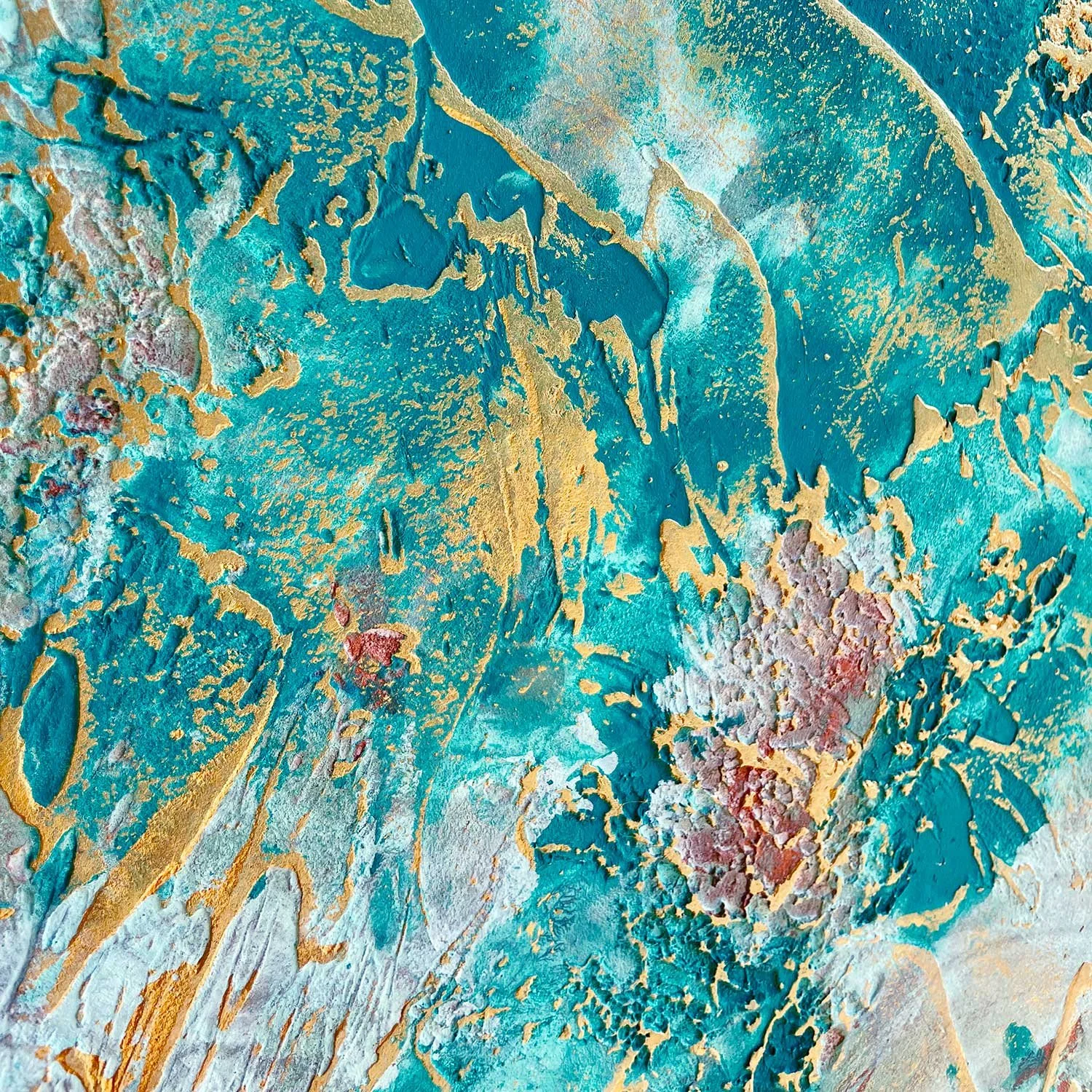 Close-up of a sideboard door with gold shimmer markings over a colourful mix of turquoise and blue tones on a textured surface.