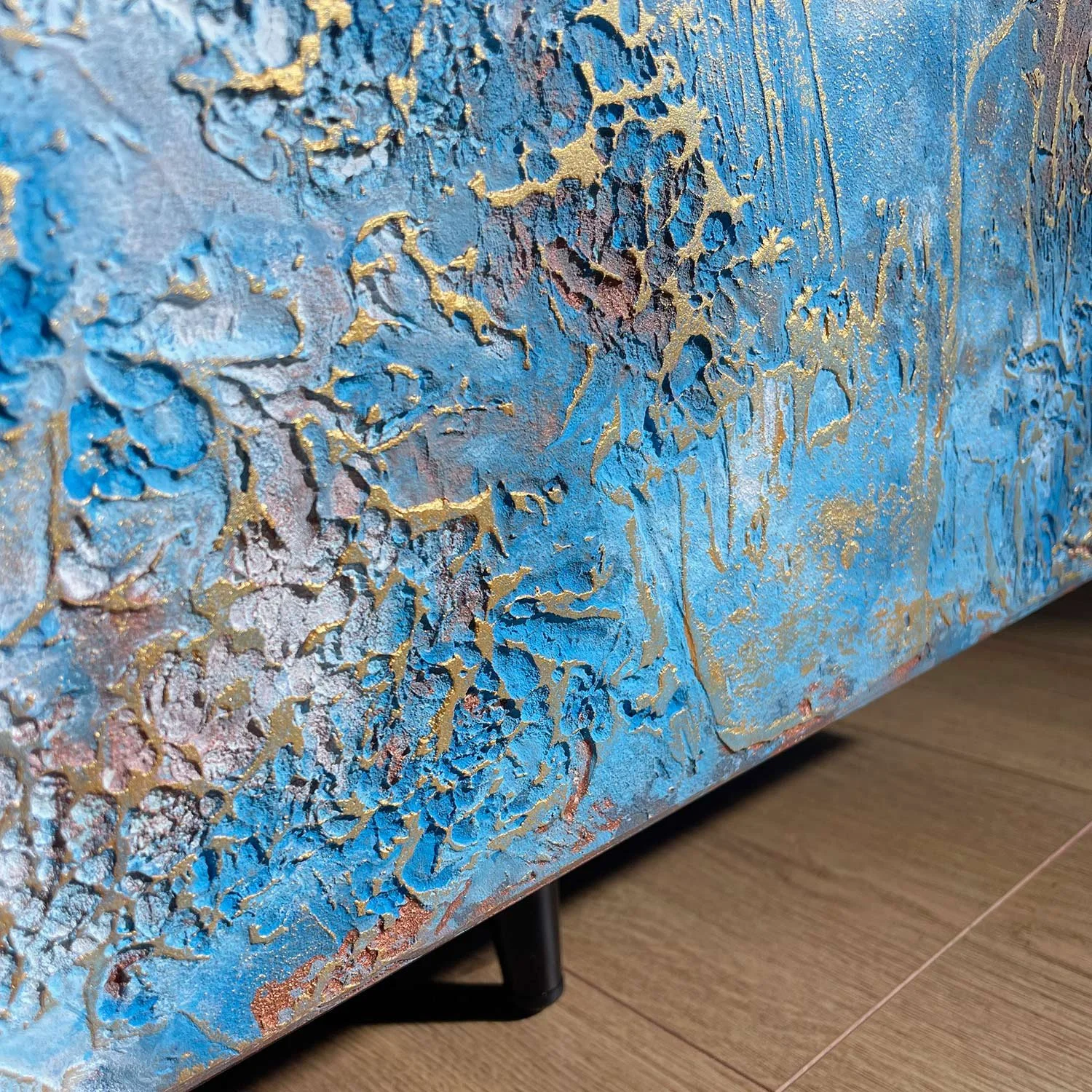Crafted oak veneer and base detail of extra large textured silver credenza showing materials and finish.