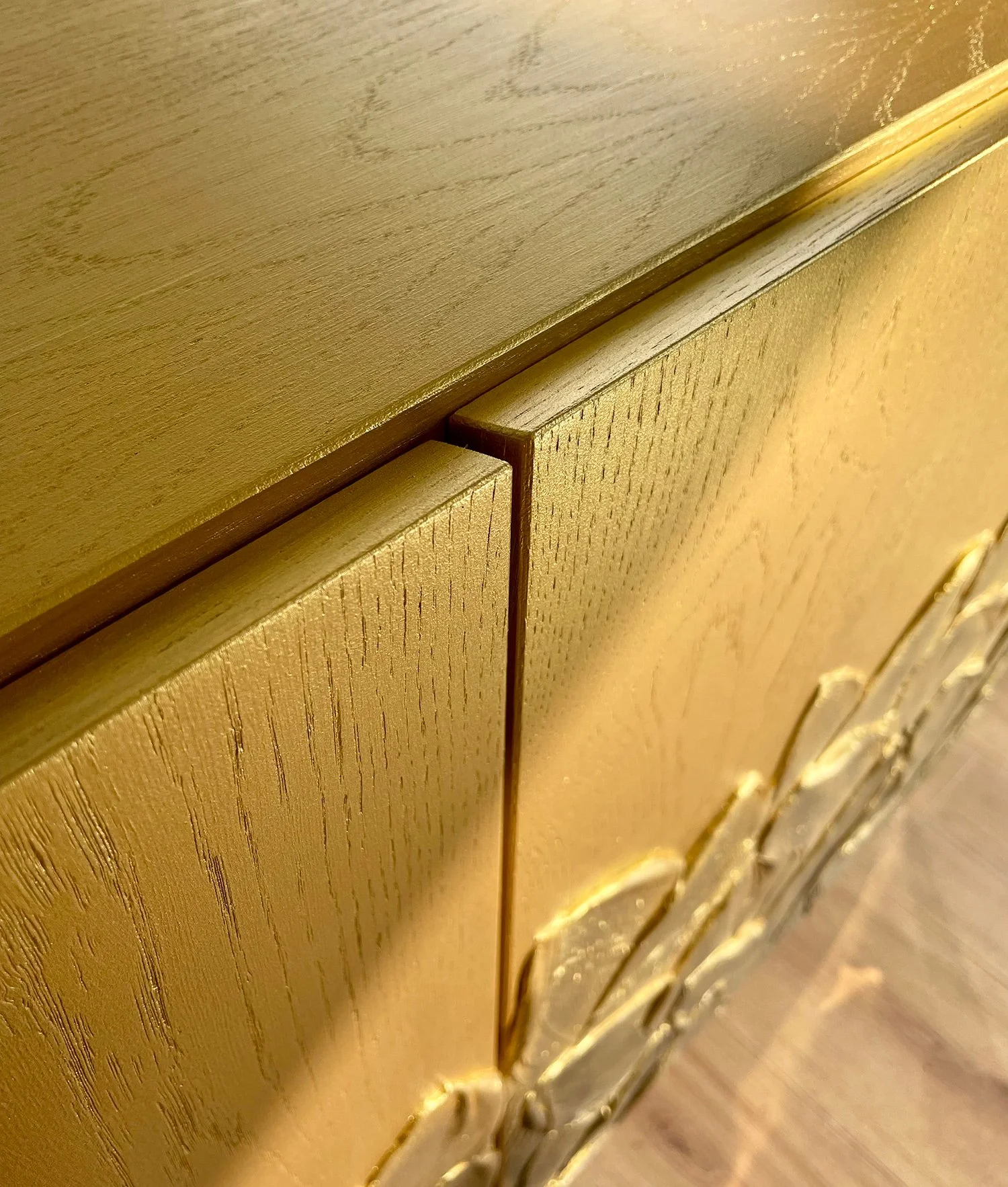 Macro shot of the expert mitred door edges on the Gold Foliage sideboard, demonstrating high-quality joinery.