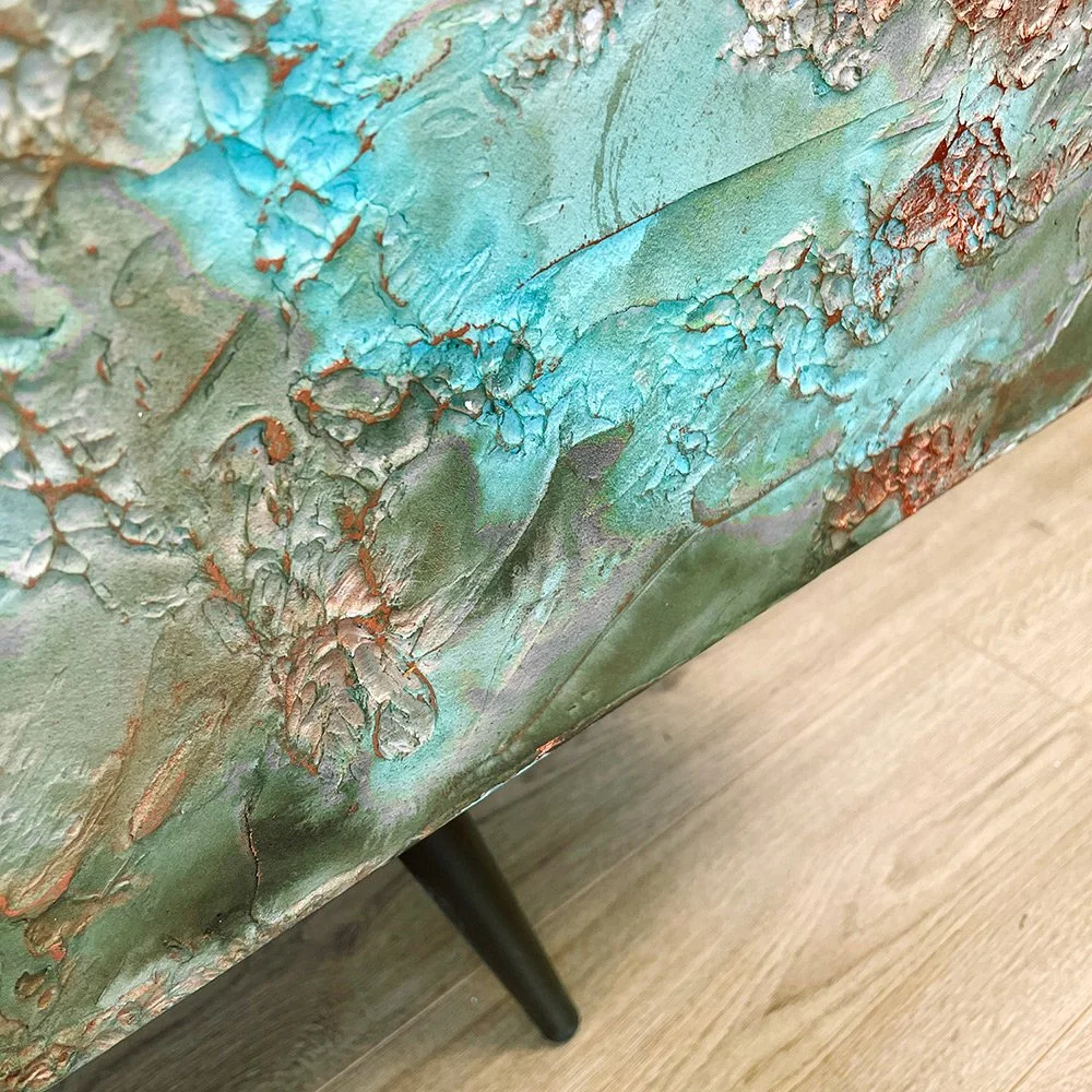 A low-angle shot showcasing the sleek, black Mid-Century Modern tapered legs that provide a sophisticated, minimalist base for the heavy-textured cabinet.