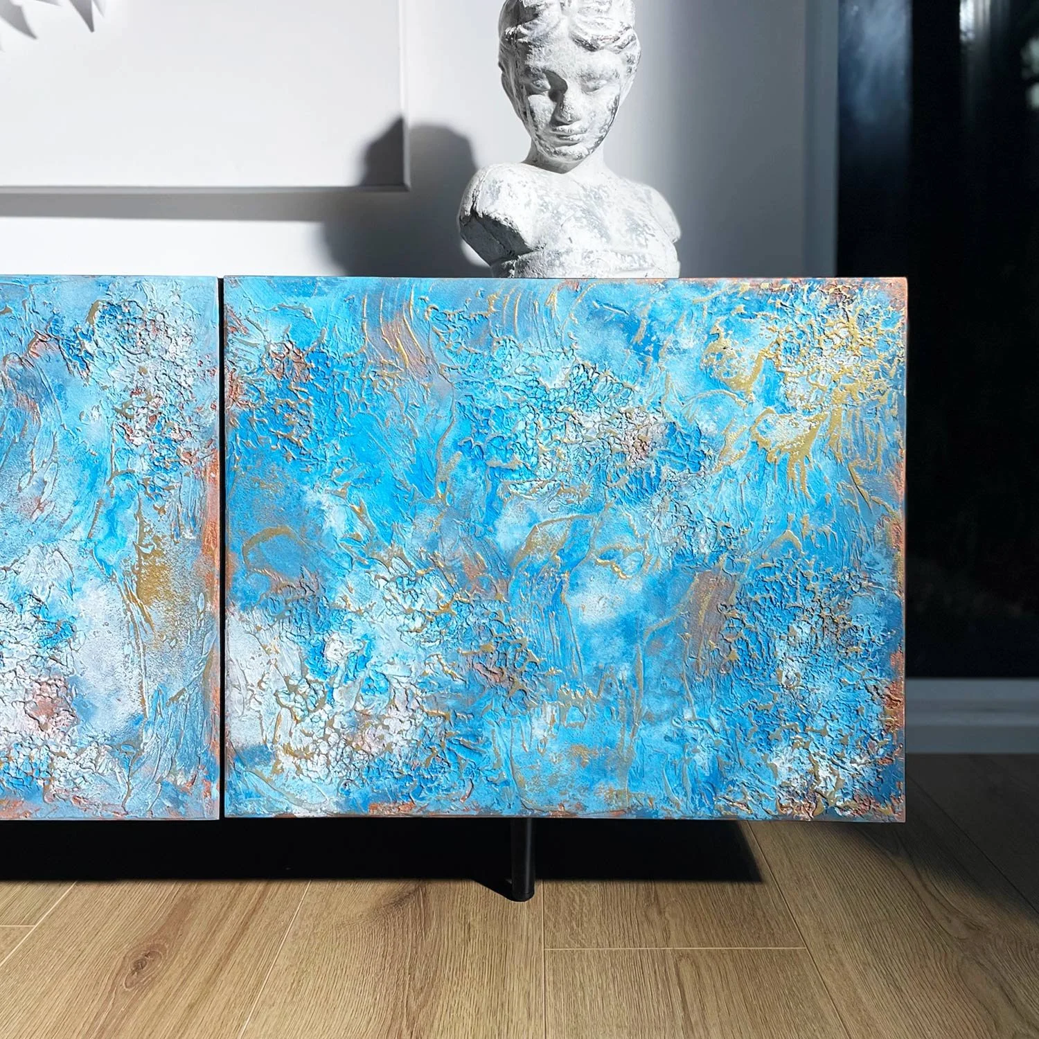 Detailed close-up of abstract hand-crafted raised texture on metallic silver finish of bespoke sideboard.