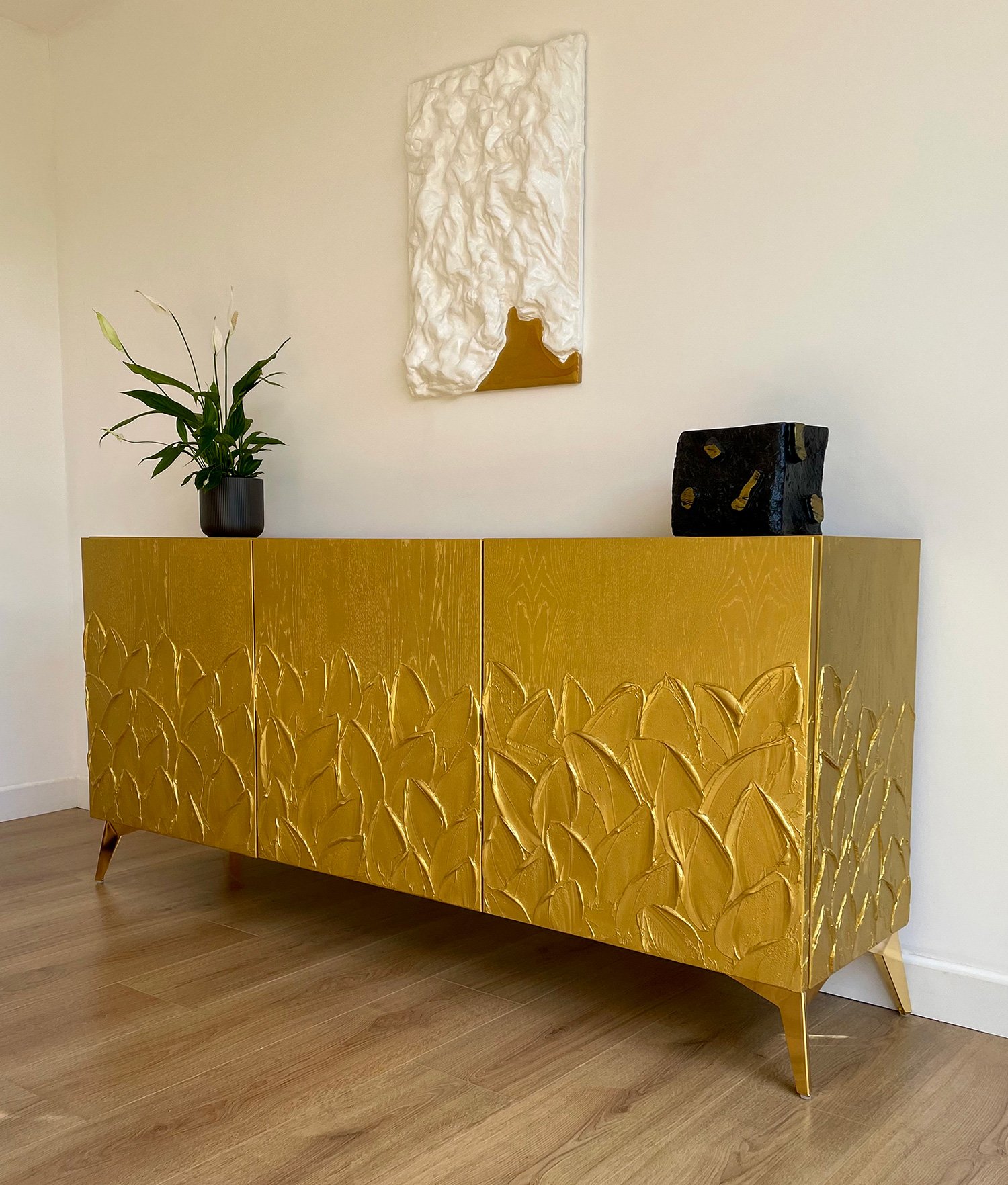 Side profile view of the Gold Foliage sideboard showing the leaf texture continuing seamlessly around the corners.