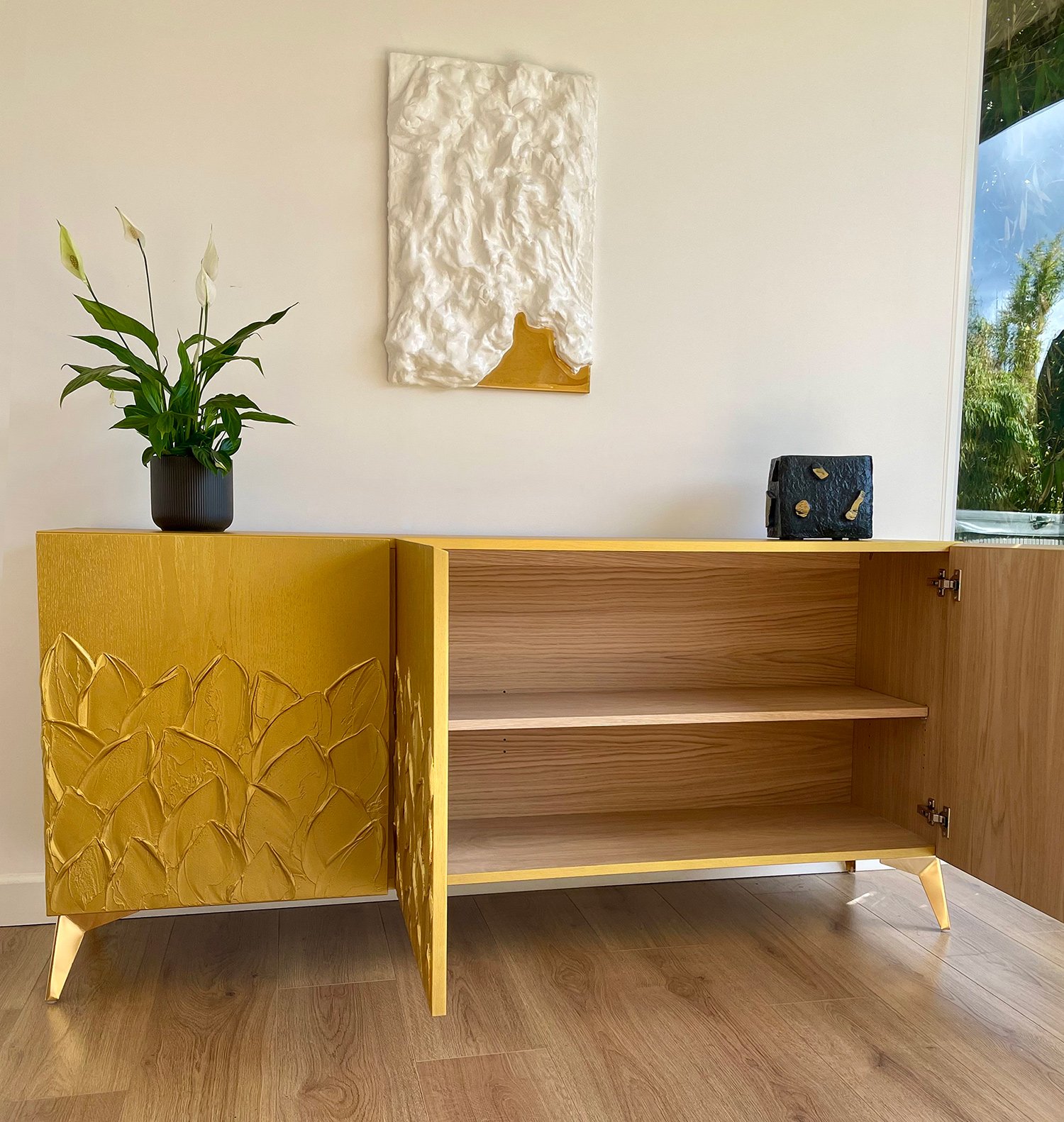 Open doors of the gold sideboard showcasing the natural European oak wood grain interior and adjustable shelving.