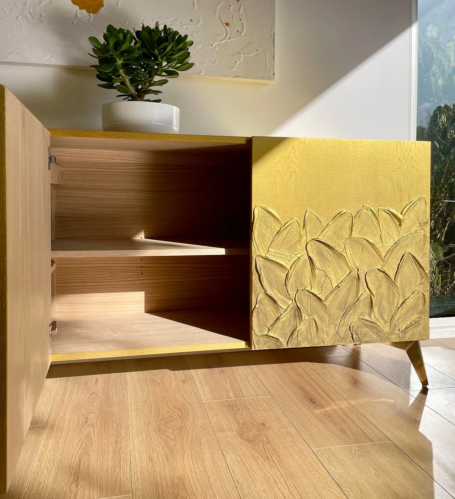 Interior of the bespoke gold sideboard, revealing the premium European oak veneer finish and adjustable shelving.
