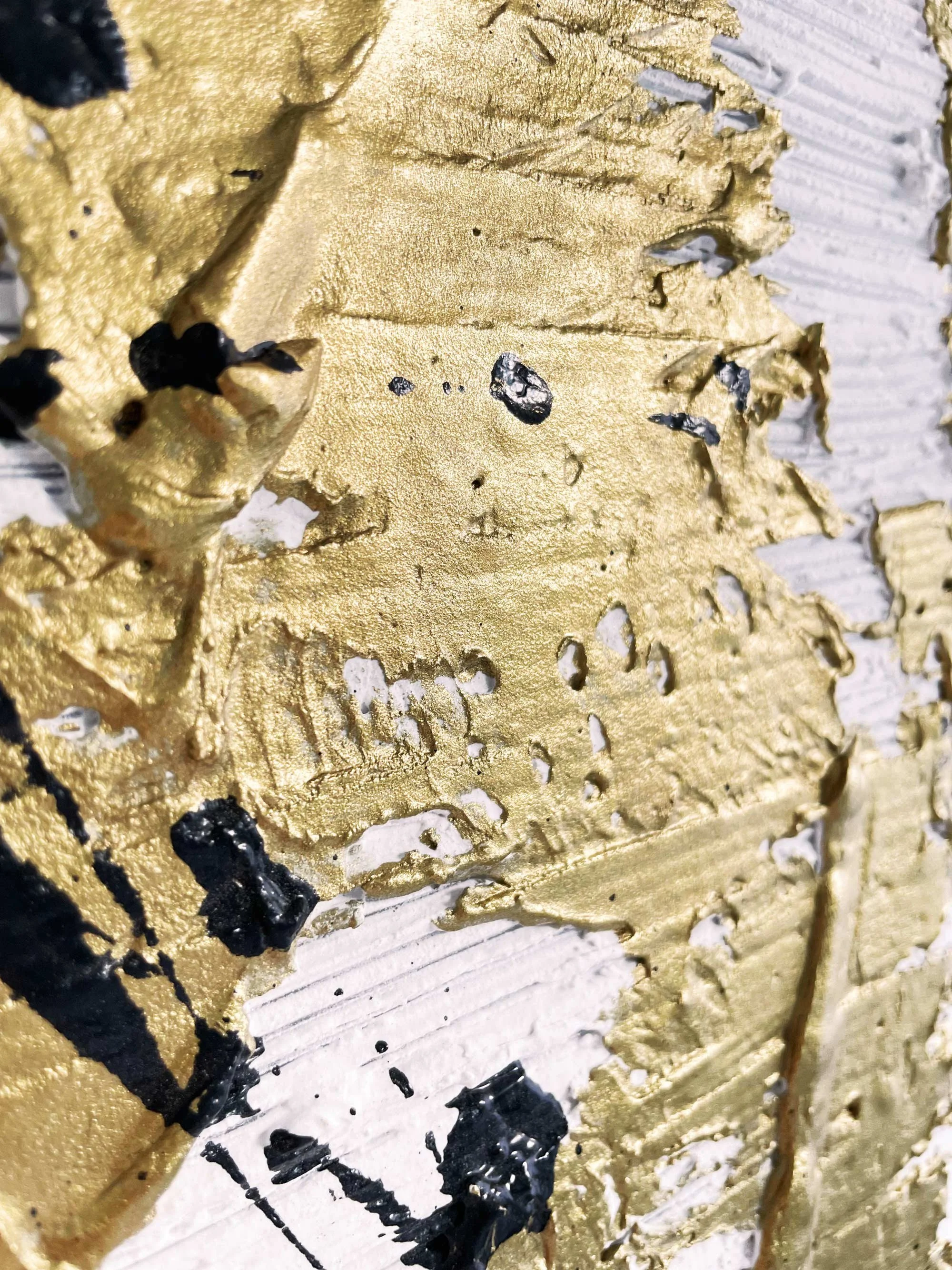 Contemporary textured artwork with gold and black details.