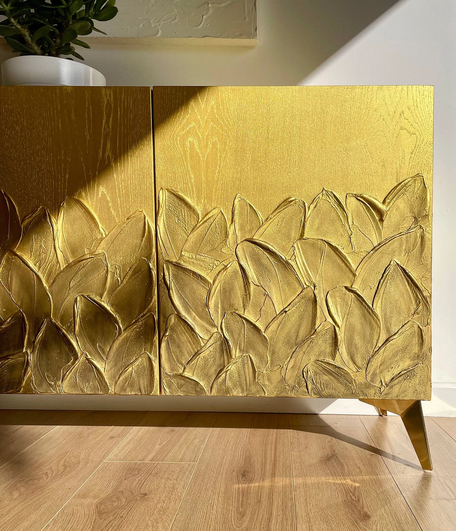 A portrait close-up focusing on a textured door to show the high-contrast 3D botanical relief.