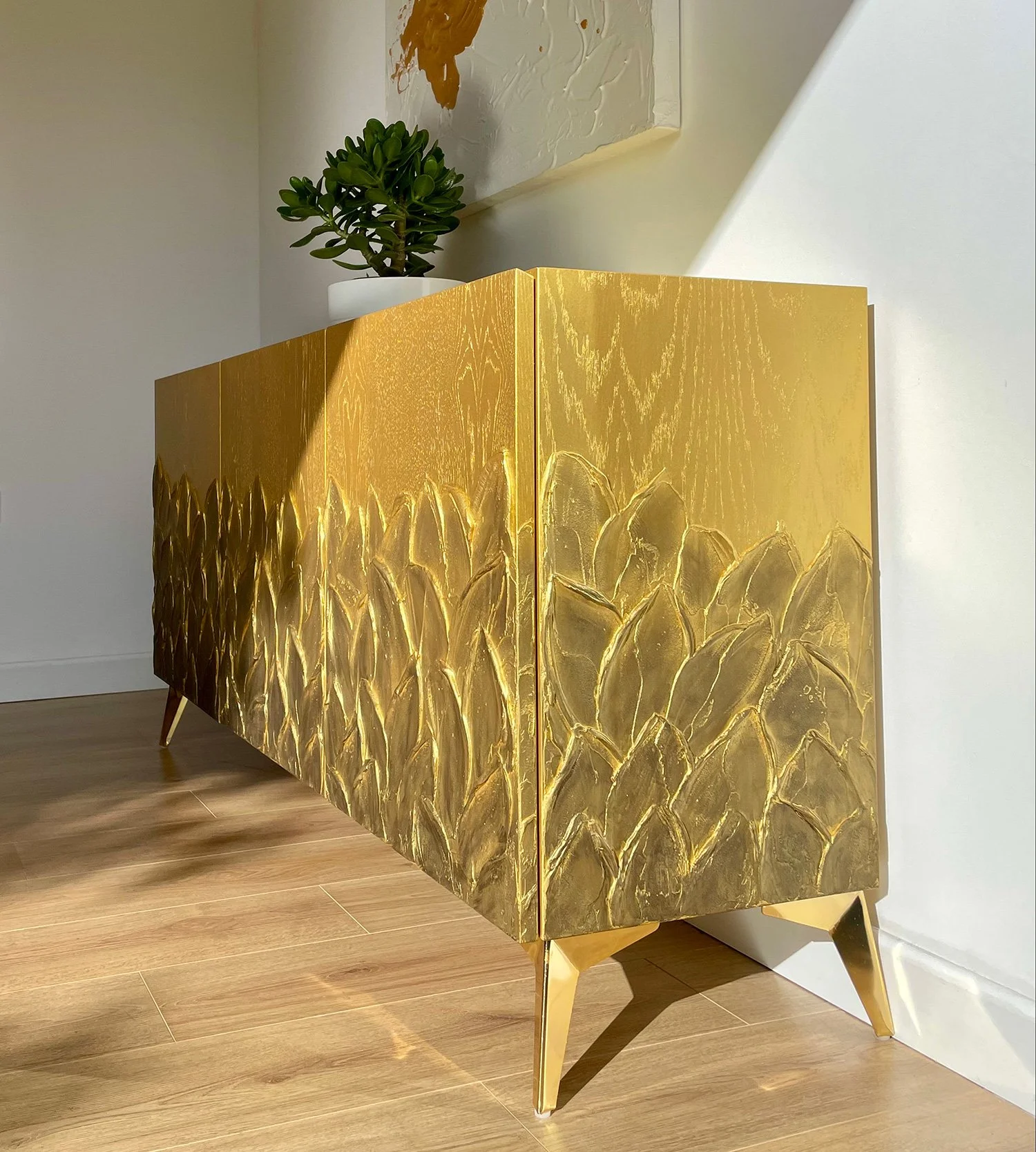 Side profile of the Gold Antiqued Foliage sideboard showcasing the handcrafted leaf texture extending across the side panels.