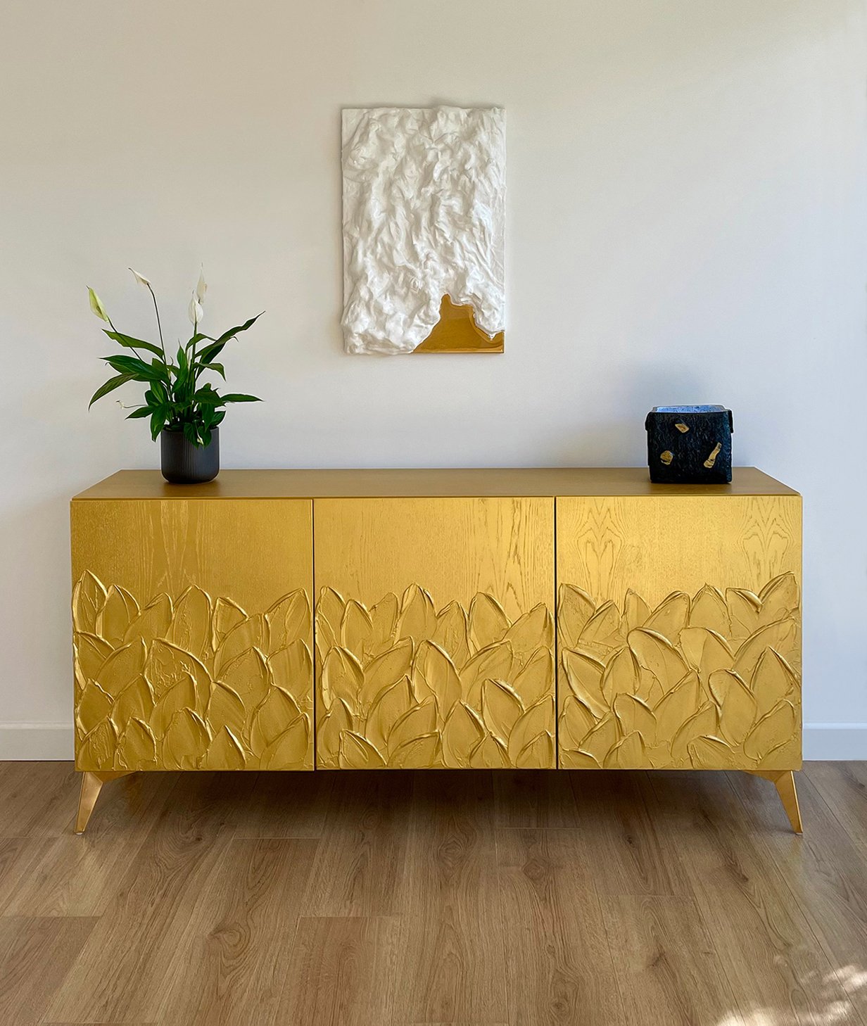 "Gold Foliage" high-end bespoke gold furniture UK: A centred front view of the 3-door sideboard showing the radiant gold finish and leaf-textured doors.