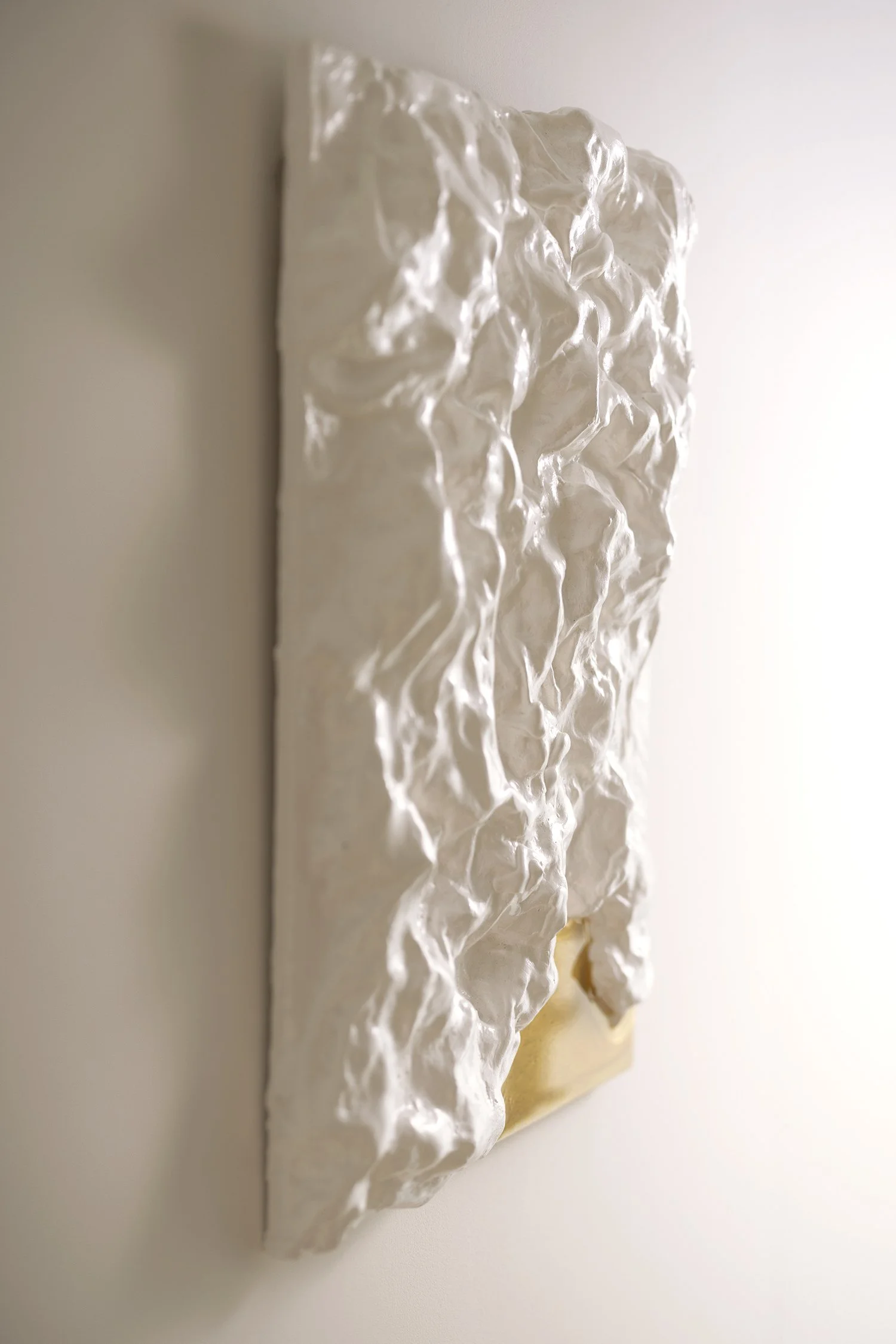 Handcrafted sculptural wall artwork in white and gold, made from recycled plastic. Textured, one-of-a-kind piece for modern luxury interiors.
