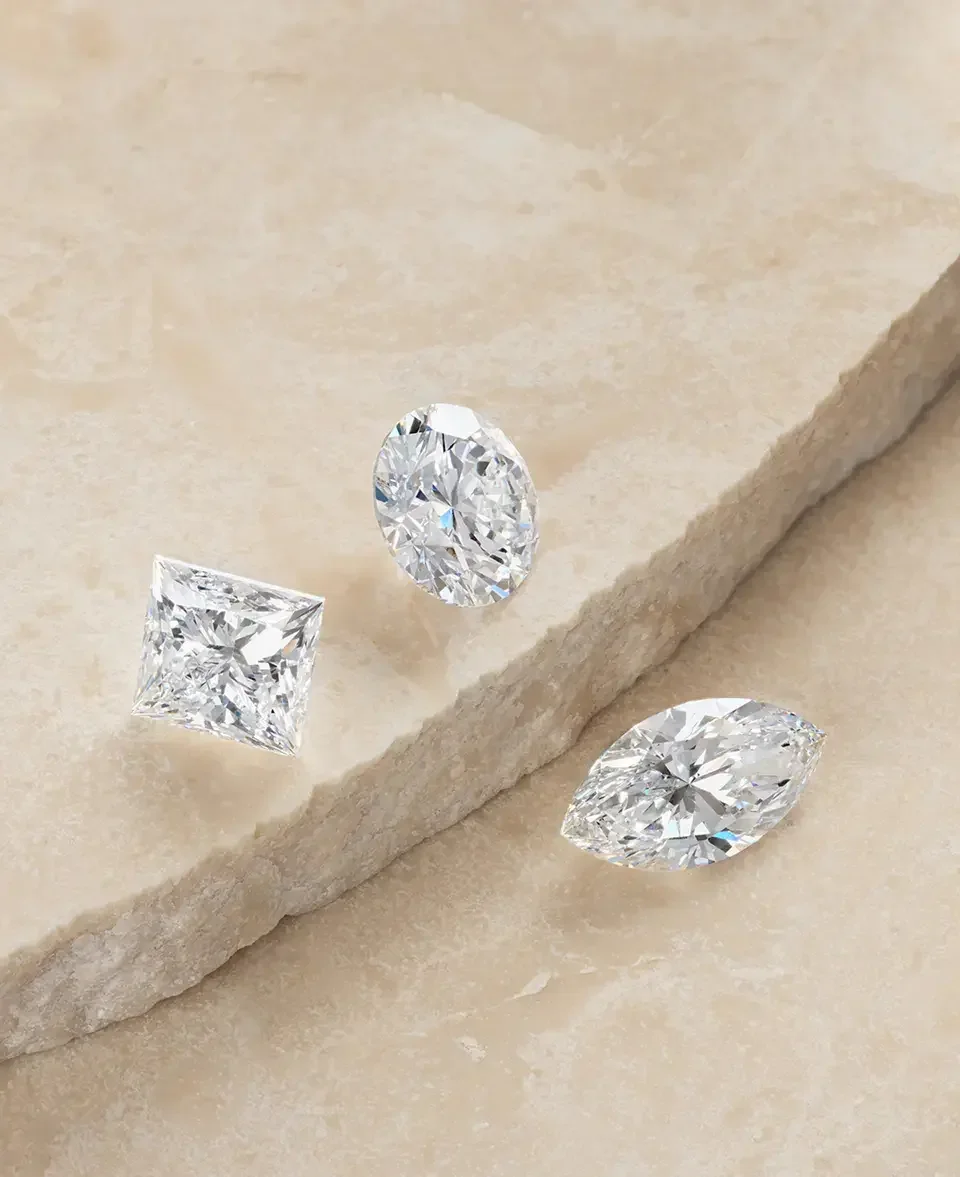 a_collection_of_loose_diamonds_spread_on_a_stone_slab.webp