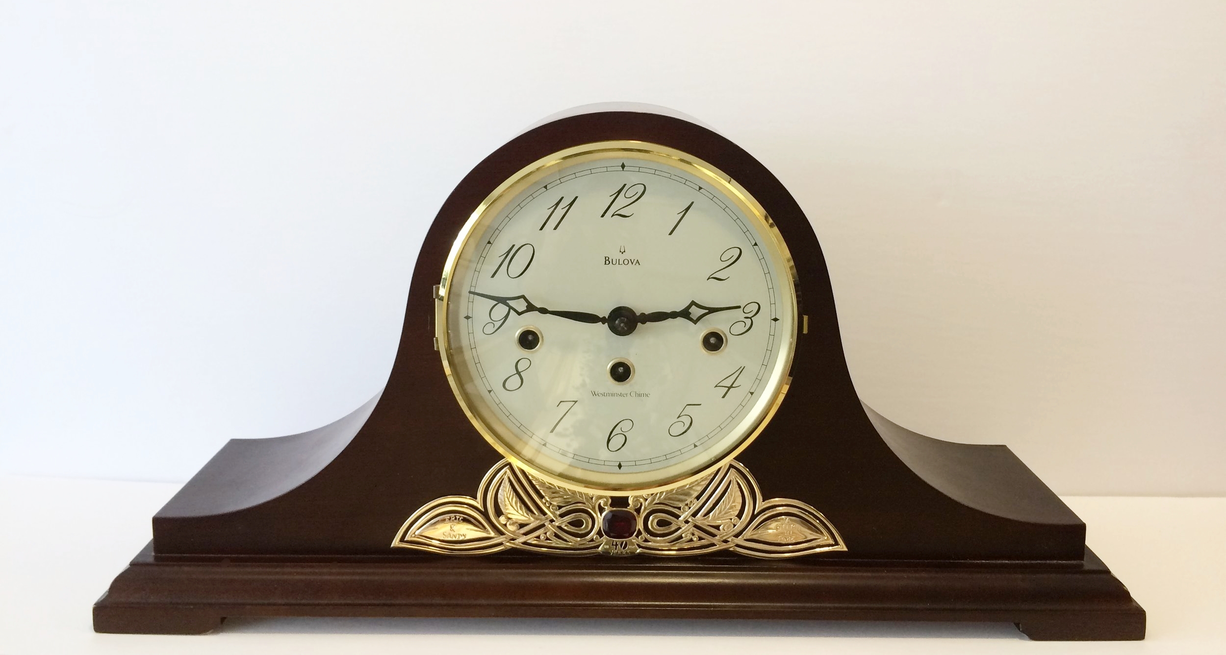  10k gold and synth ruby mounted to heirloom mantle clock. 
