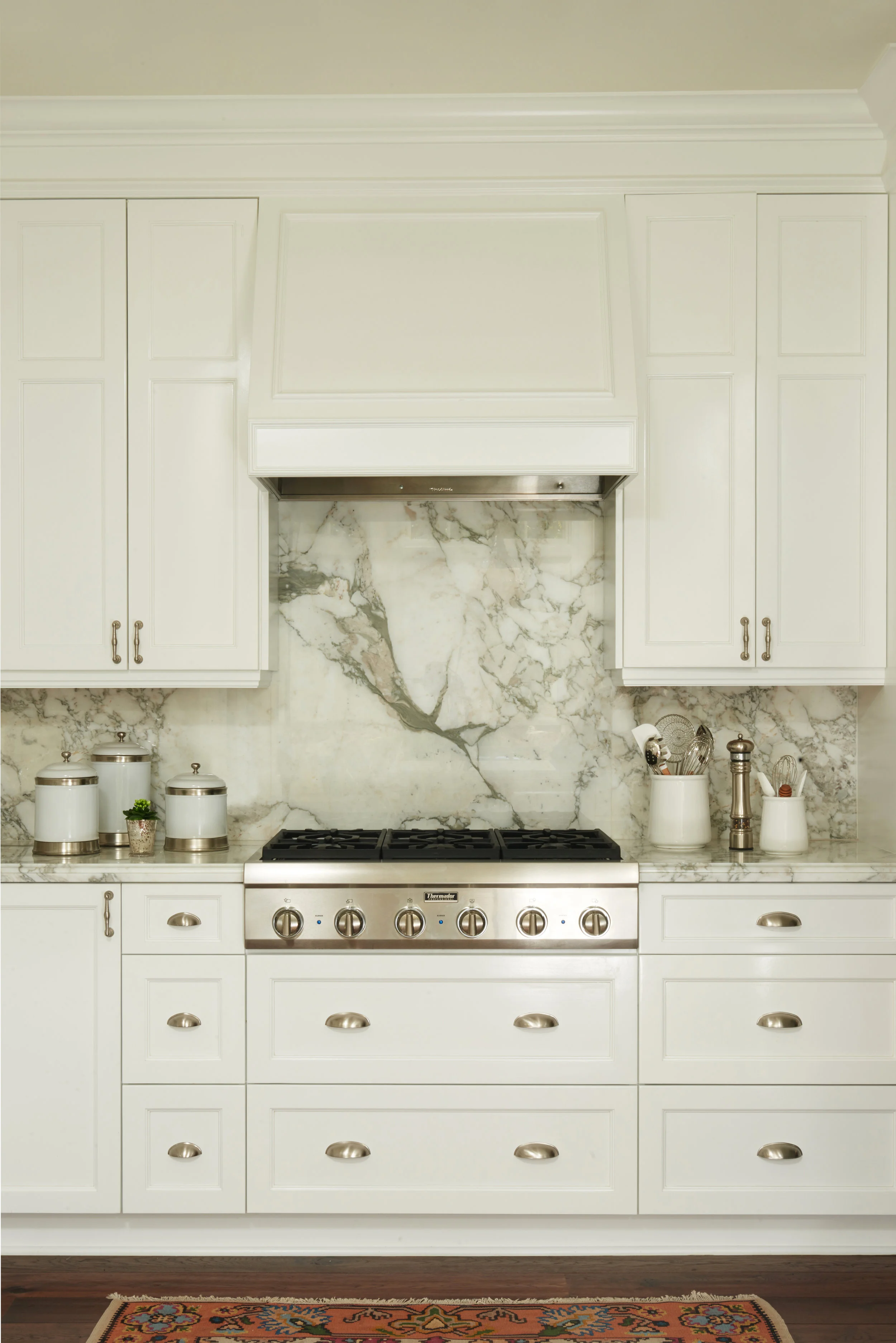 Luxury Kitchen with Marble Backsplash & White Cabinets