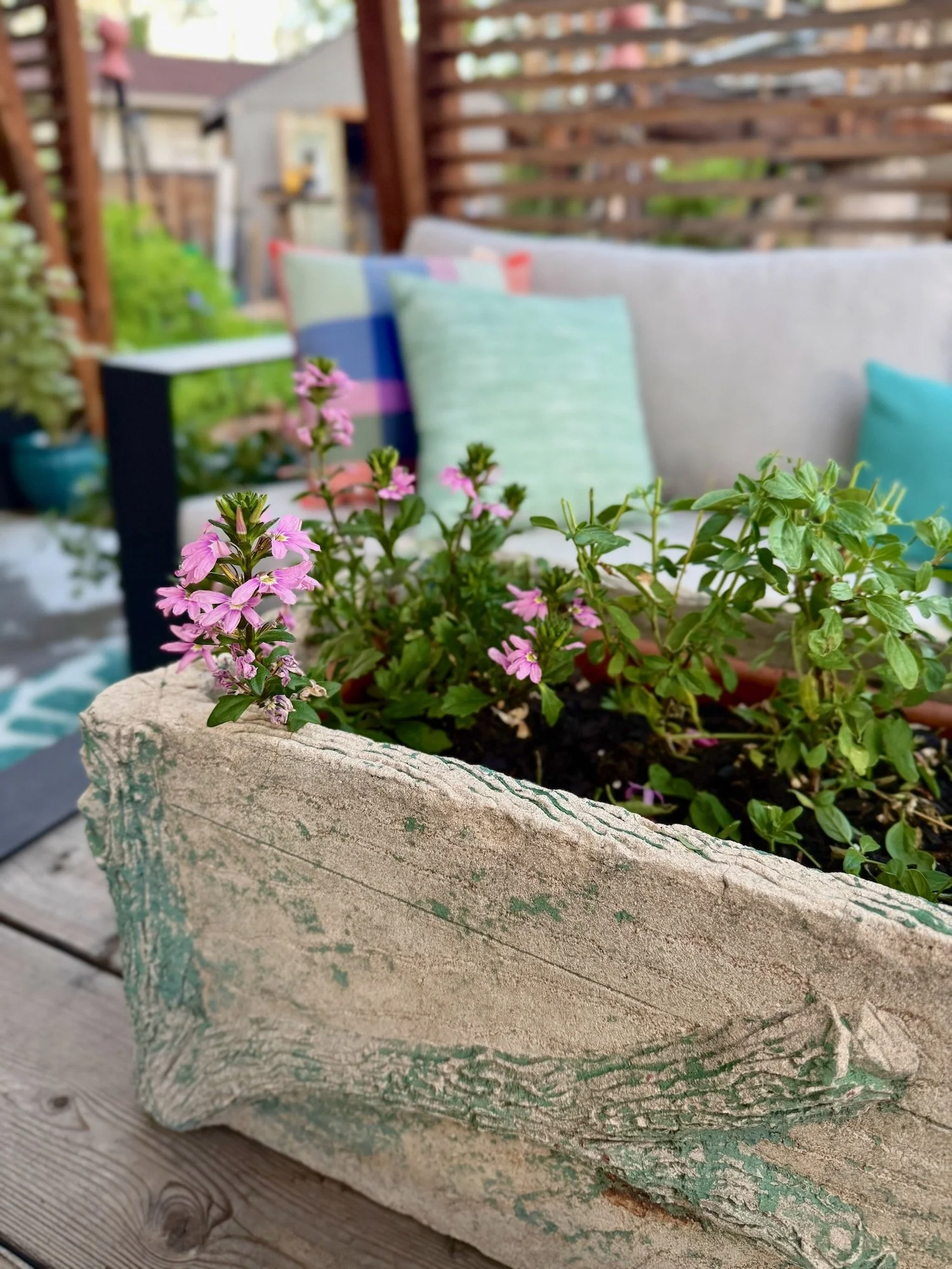 This antique faux bois planter sits all summer on the coffee table filled with flowers.
