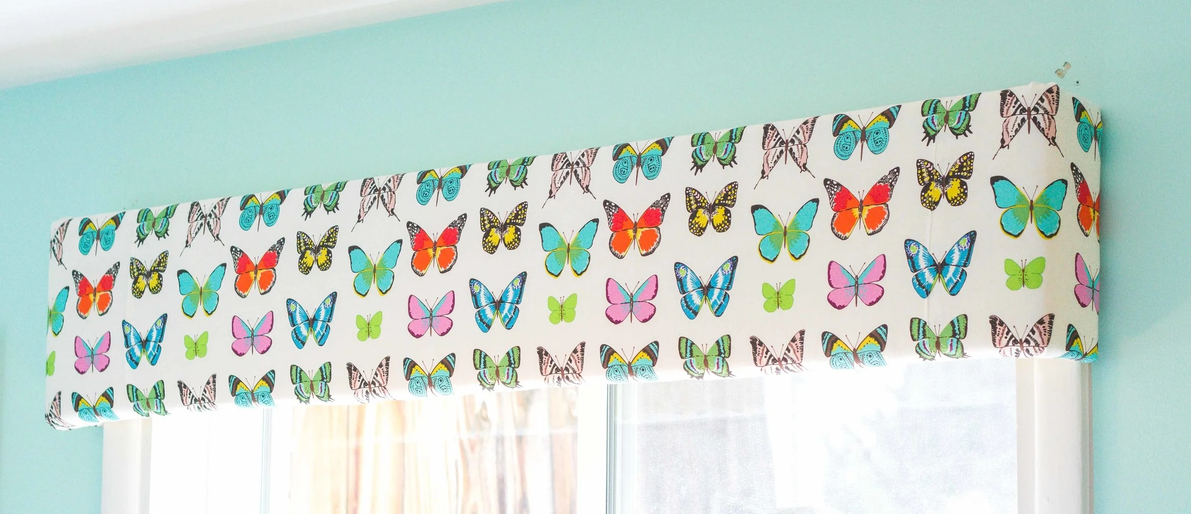 Easy DIY window valances allow the maximum amount of light and conceal shades for privacy.