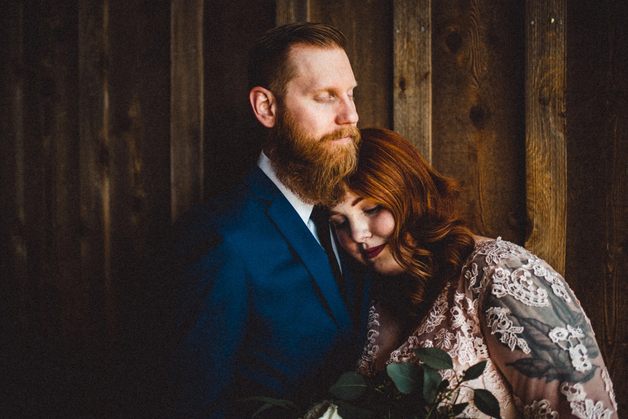 bride resting head on groom's shoulder