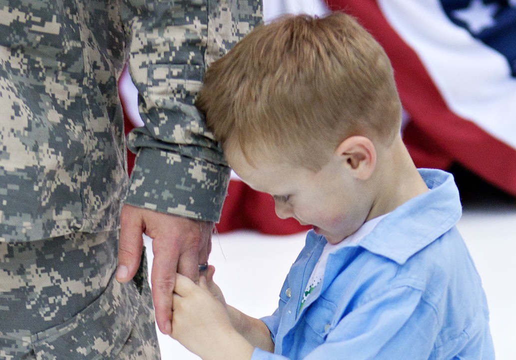 My youngest son, Everett, holds my hand during the Homecoming Ceremony from my final deployment to Afghanistan in 2011.