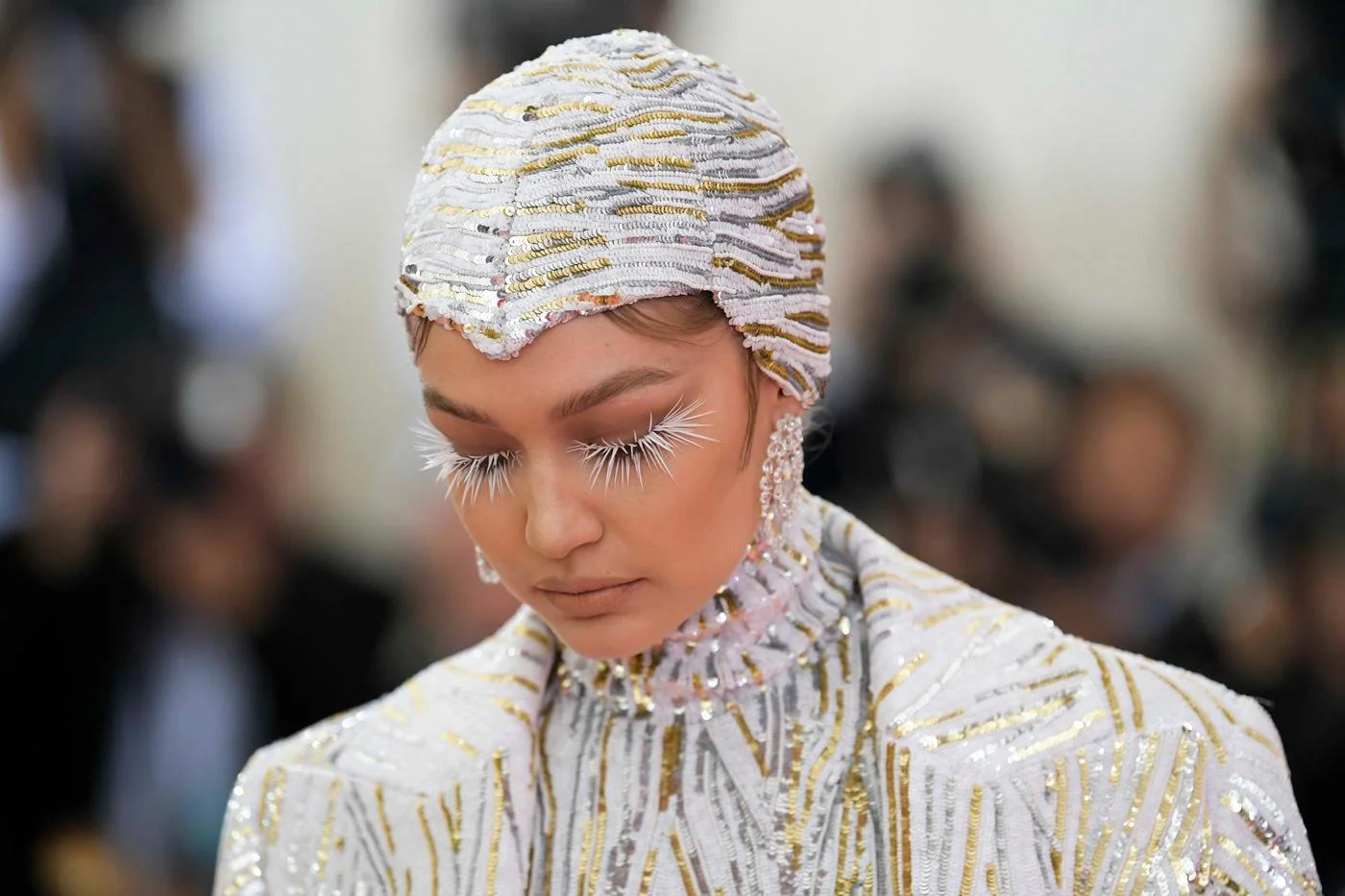 Gigi Hadid in Michael Kors outfit and long white wispy lashes.