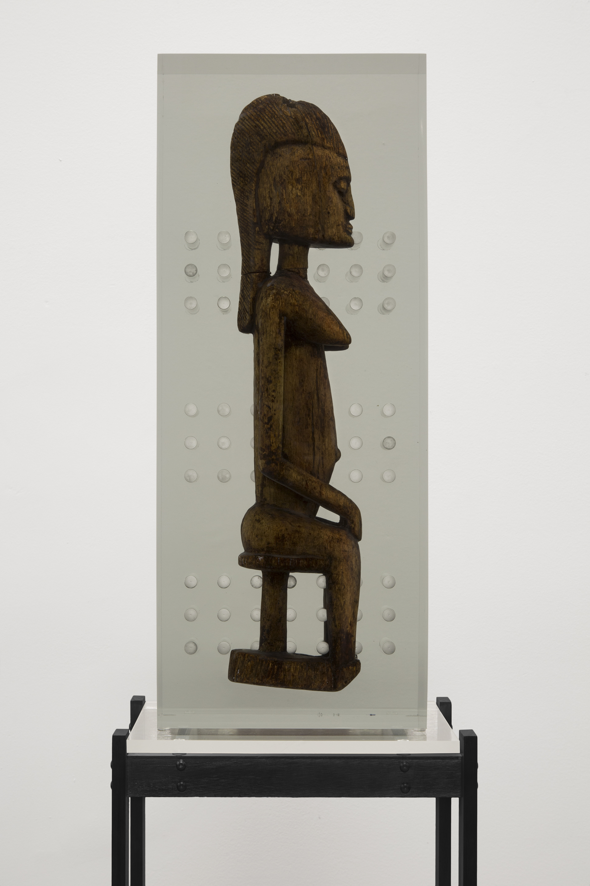  Matthew Angelo Harrison,  Dark Silhouette: Fixtured Woman , 2018, Wooden sculpture from West Africa, polyurethane. resin, anodized aluminum, acrylic. 72 x 23 x 15 1/2 inches 