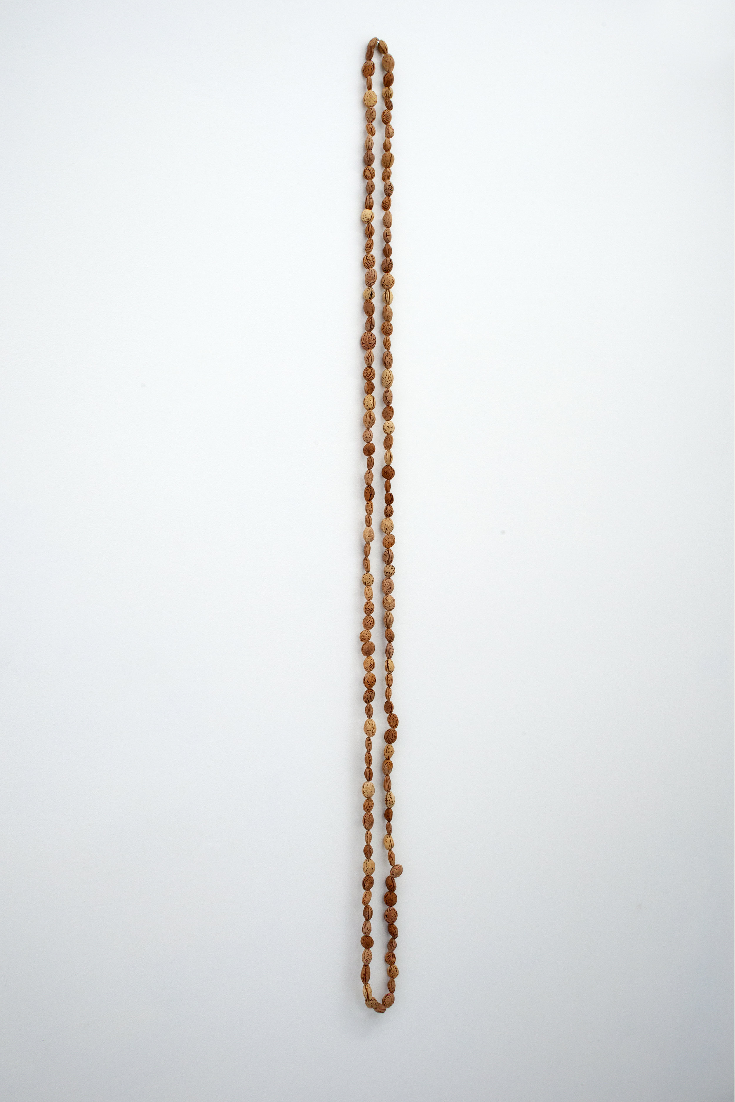  Elizabeth Atterbury,  Beads III , 2018, Peach Pits, 61.50 x 1 x 1 in 