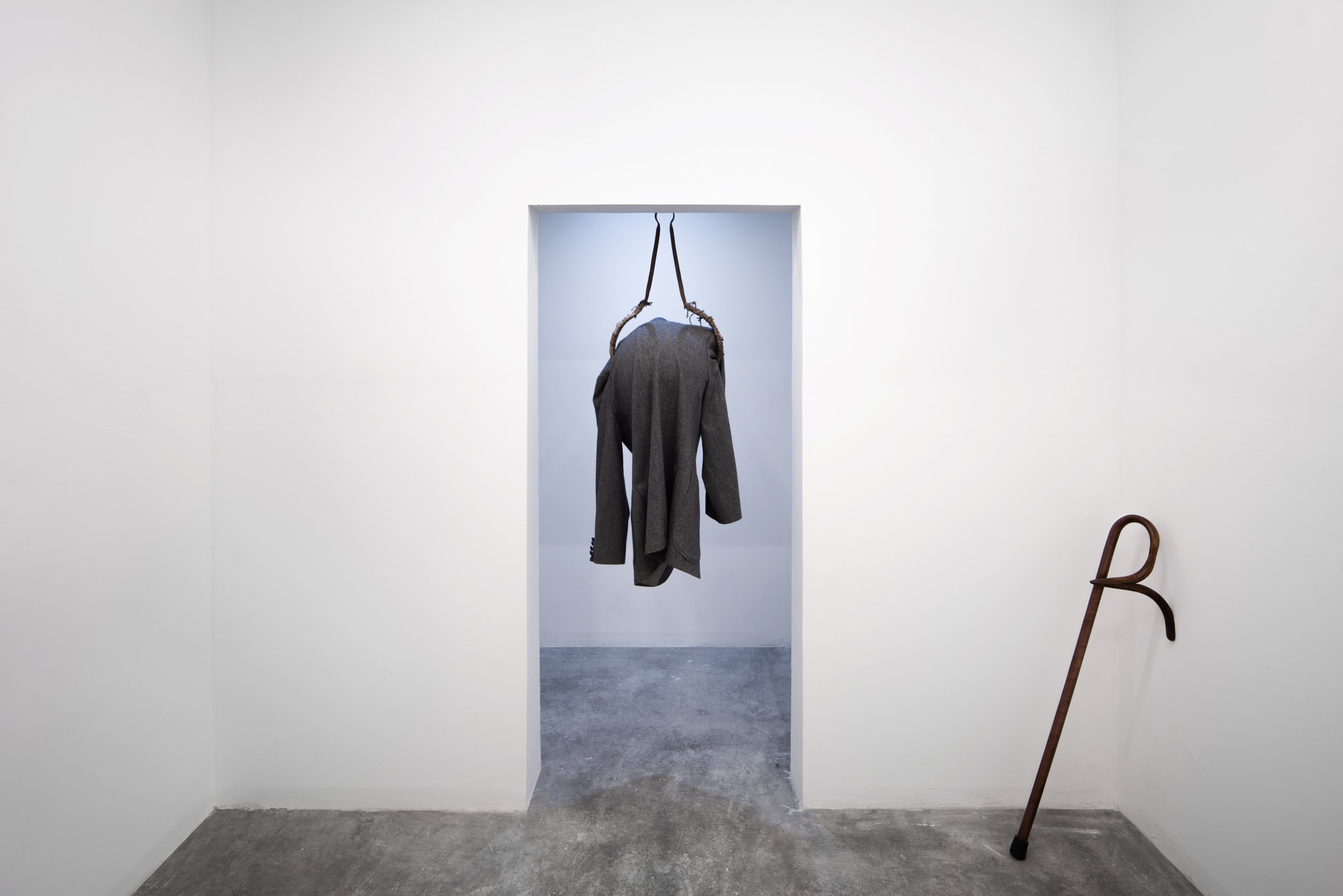  Moch Hahn,  You're Late , 2018, Found suit coat, metal, rope, plastic globe 46'' x 17'' x 14''  