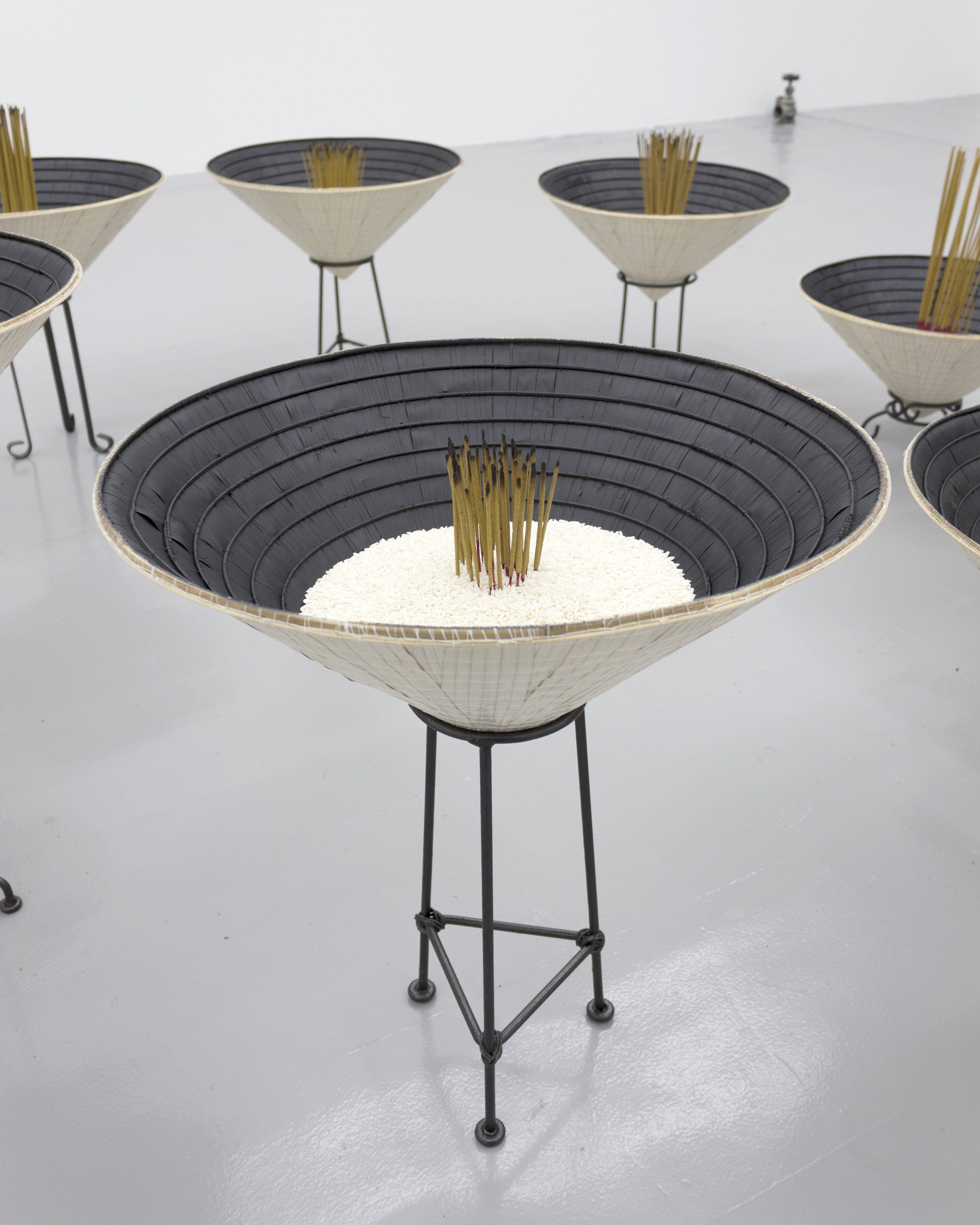  Millian Giang Lien Pham,  Reforge: 9 Phases (Seven),  2019. Conical hat, sweet rice, incense, metal stand 